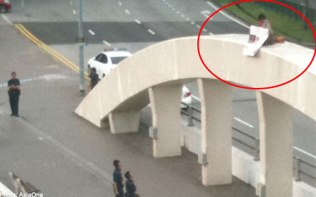 WOMAN ARRESTED FOR PROTESTING ON TOP OF BRIDGE NEAR ICA BUILDING