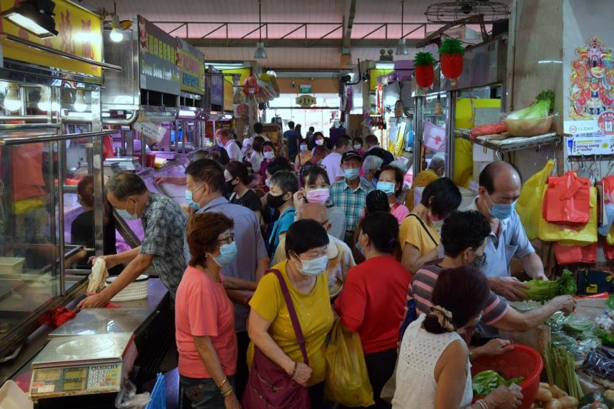 Customers at Chong Pang Wet Market on Feb 9, 2021. Only 150 patrons were allowed inside the market. PHOTO: The Straits Times