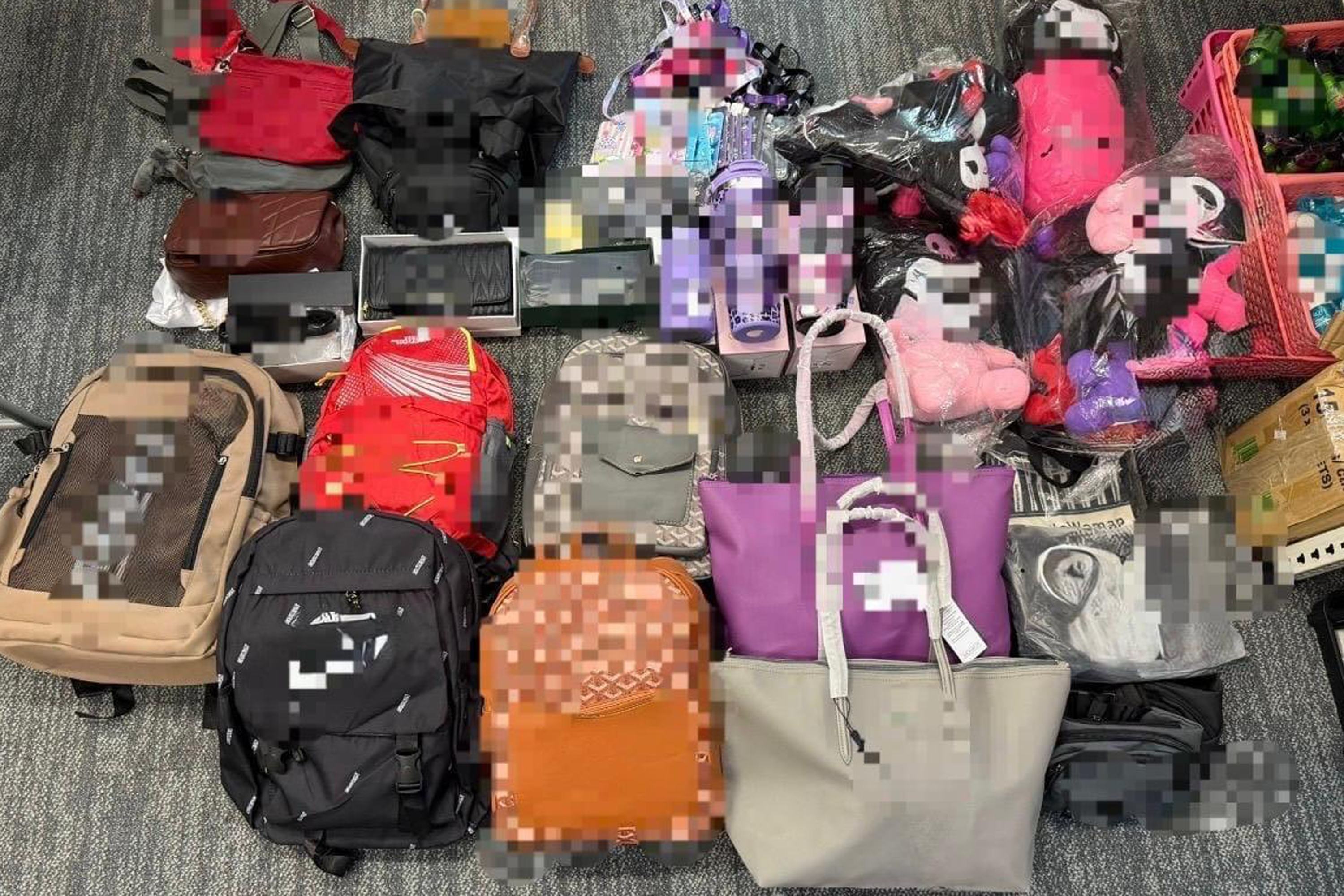 Allegedly fake luxury bags, wallets and pouches were among the over 400 items seized.