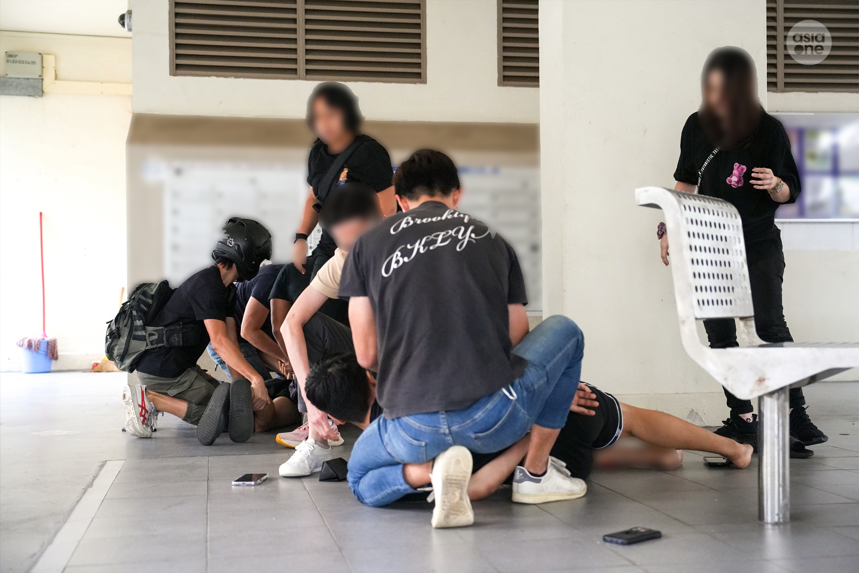 CNB officers arresting the 26-year-old alleged trafficker and a 28-year-old alleged buyer at the void deck of a HDB block in Telok Blangah Rise.