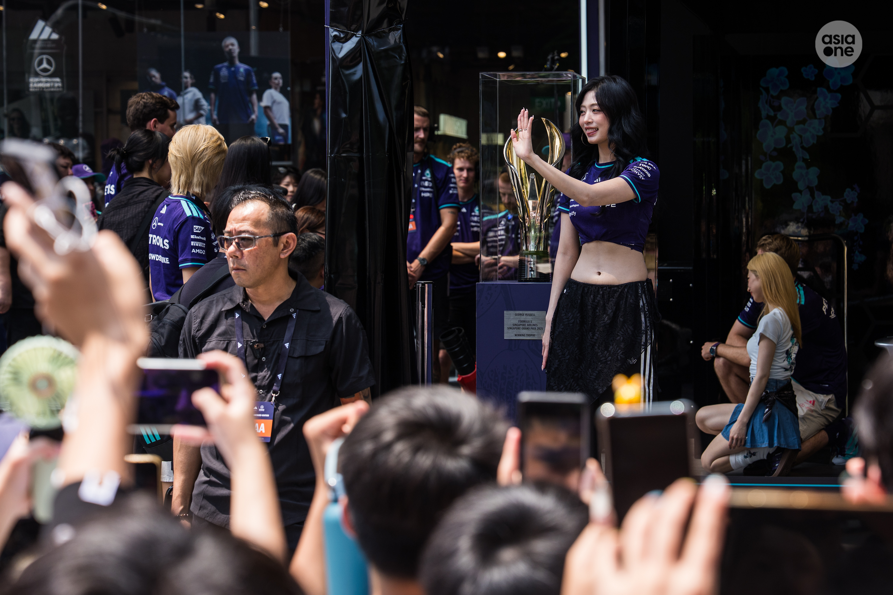 Babymonster's Ahyeon waves to friends before going for a series of hot laps with Fred Vesti.