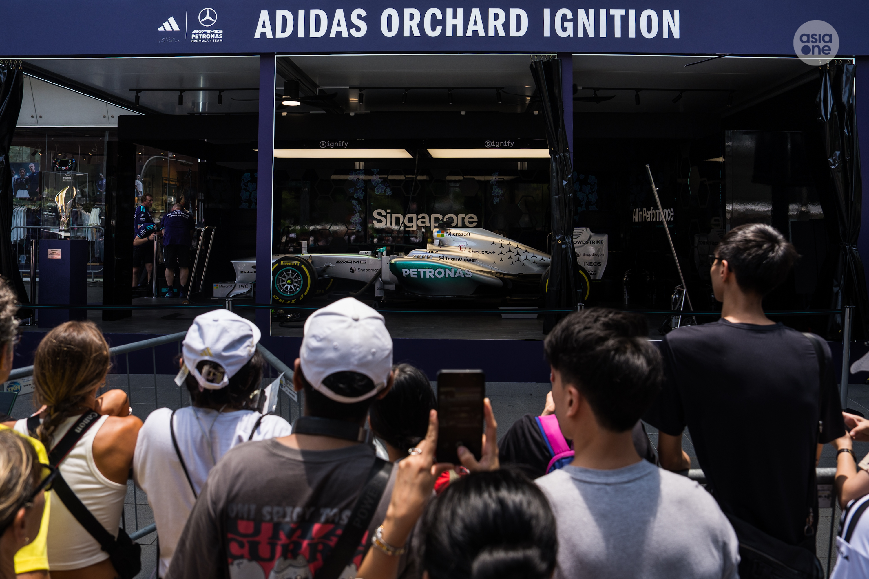 F1 fans getting a peek of the Mercedes-AMG F1 car.