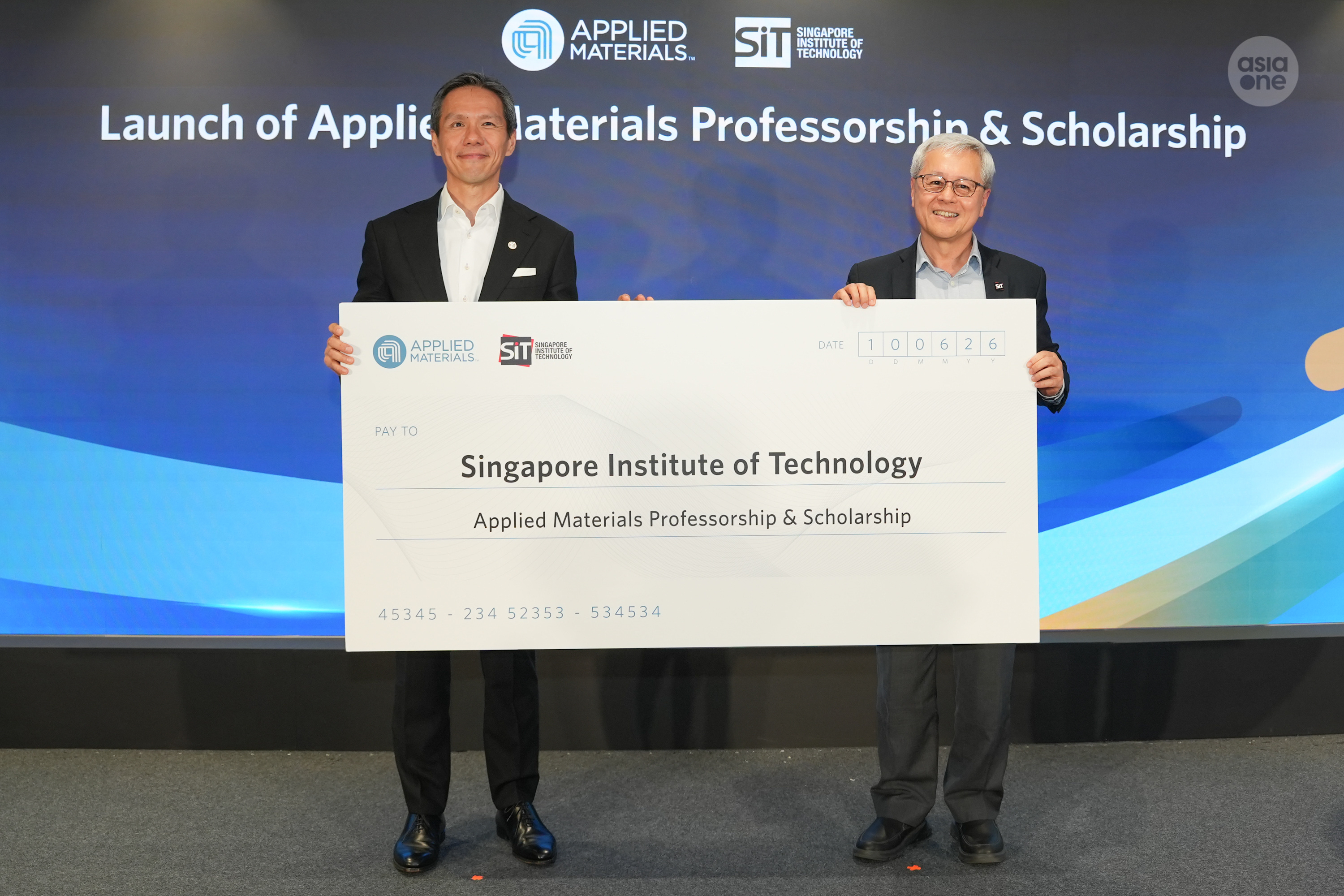 Group vice president of worldwide manufacturing at Applied Materials, KC Ong (left), presenting a mock cheque to SIT's president Professor Chua Kee Chaing on Wednesday (June 10). 