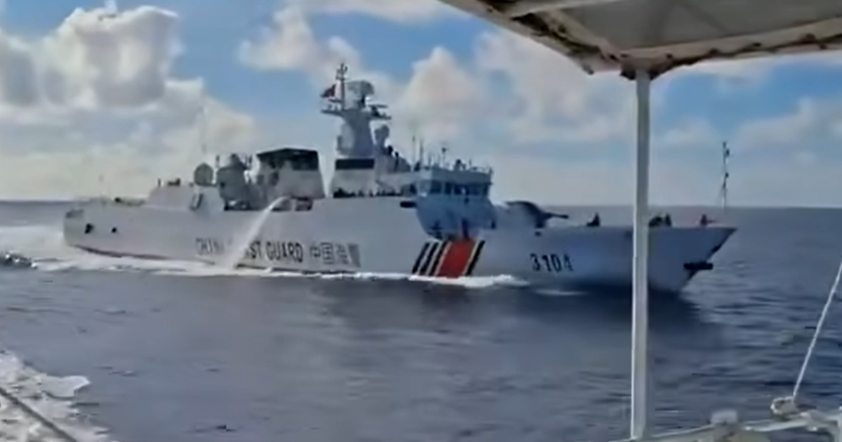 Chinese coast guard vessel 3104 seen with a water canon operating on its starboard (right) side.
