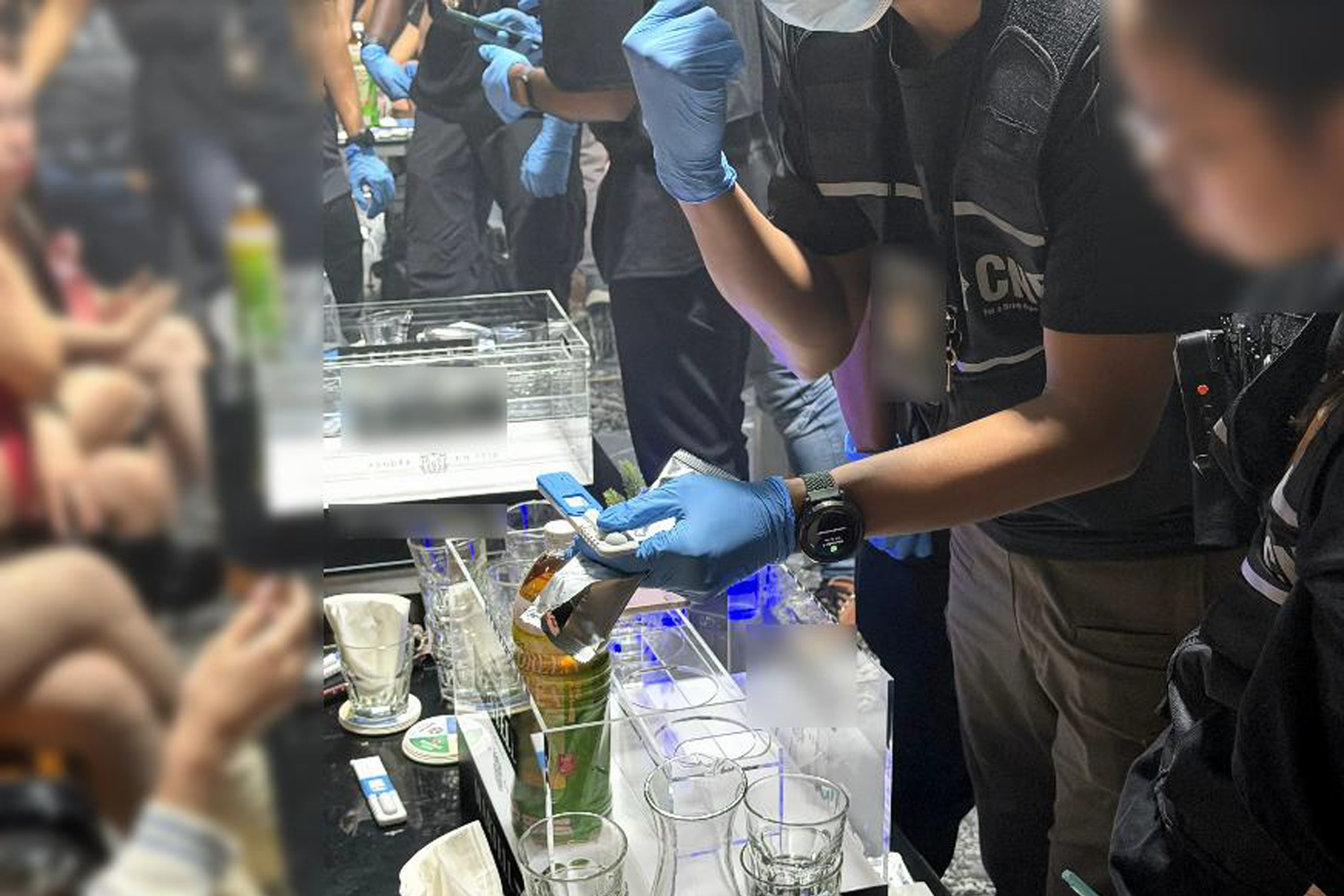 CNB officers conducting saliva tests at a nightlife establishment during a joint enforcement operation on Oct 8.