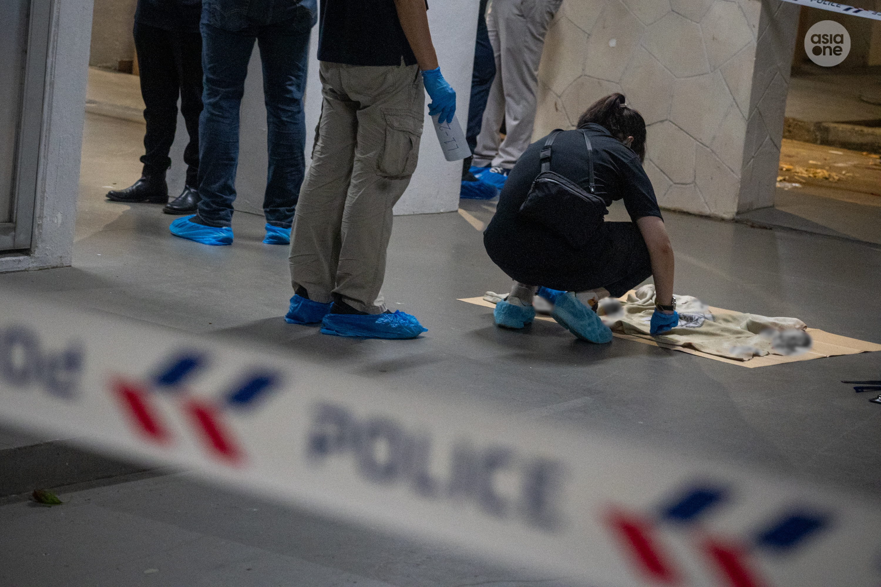 Crime scene specialists documenting an exhibit.