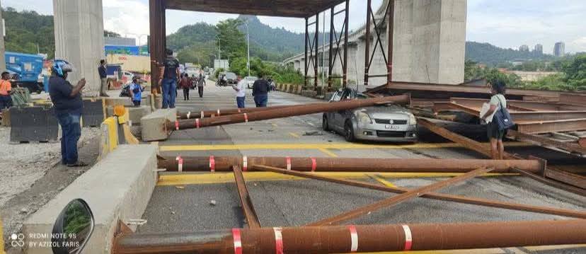 The female driver of the car crushed by the structure's collapse (far right) escaped unharmed. 