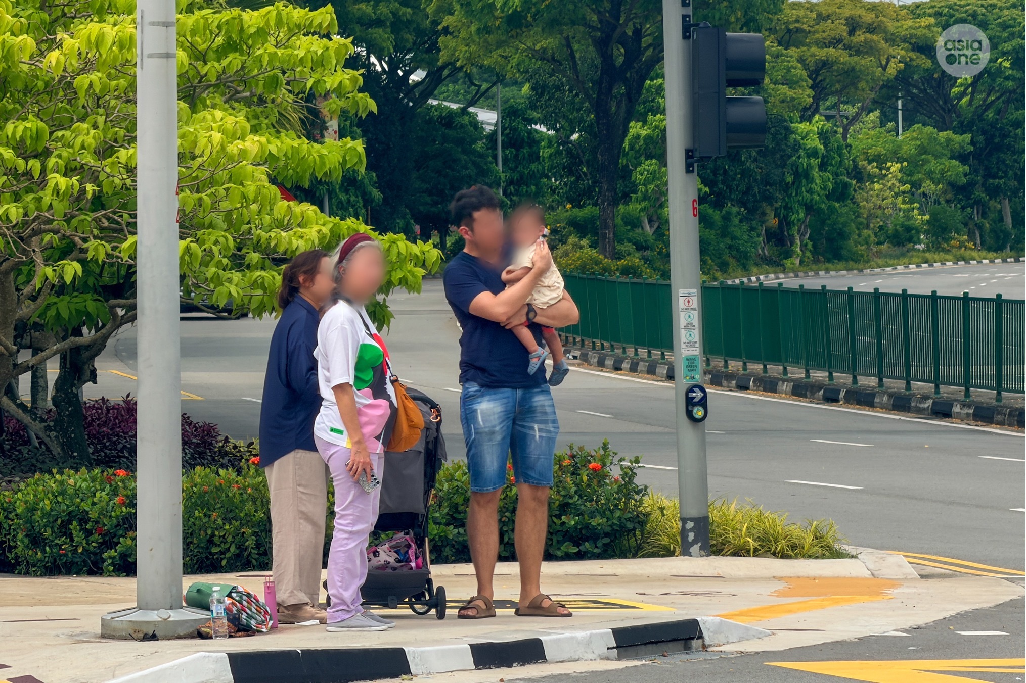 Four persons, including a toddler, believed to be passengers on board the taxi during the accident, were seen at the traffic island.