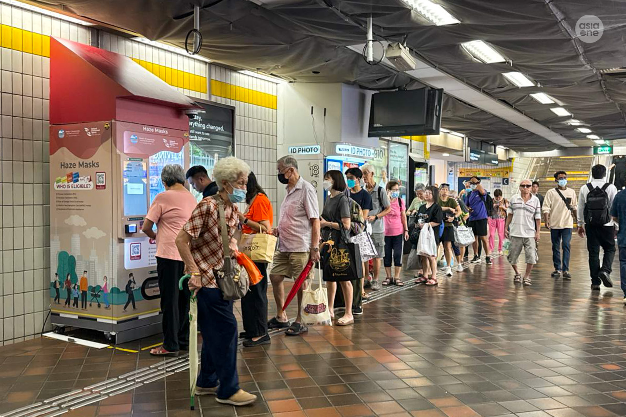 Eligible Singaporeans queuing to collect their N95 mask packs at Toa Payoh bus interchange on Oct 16.