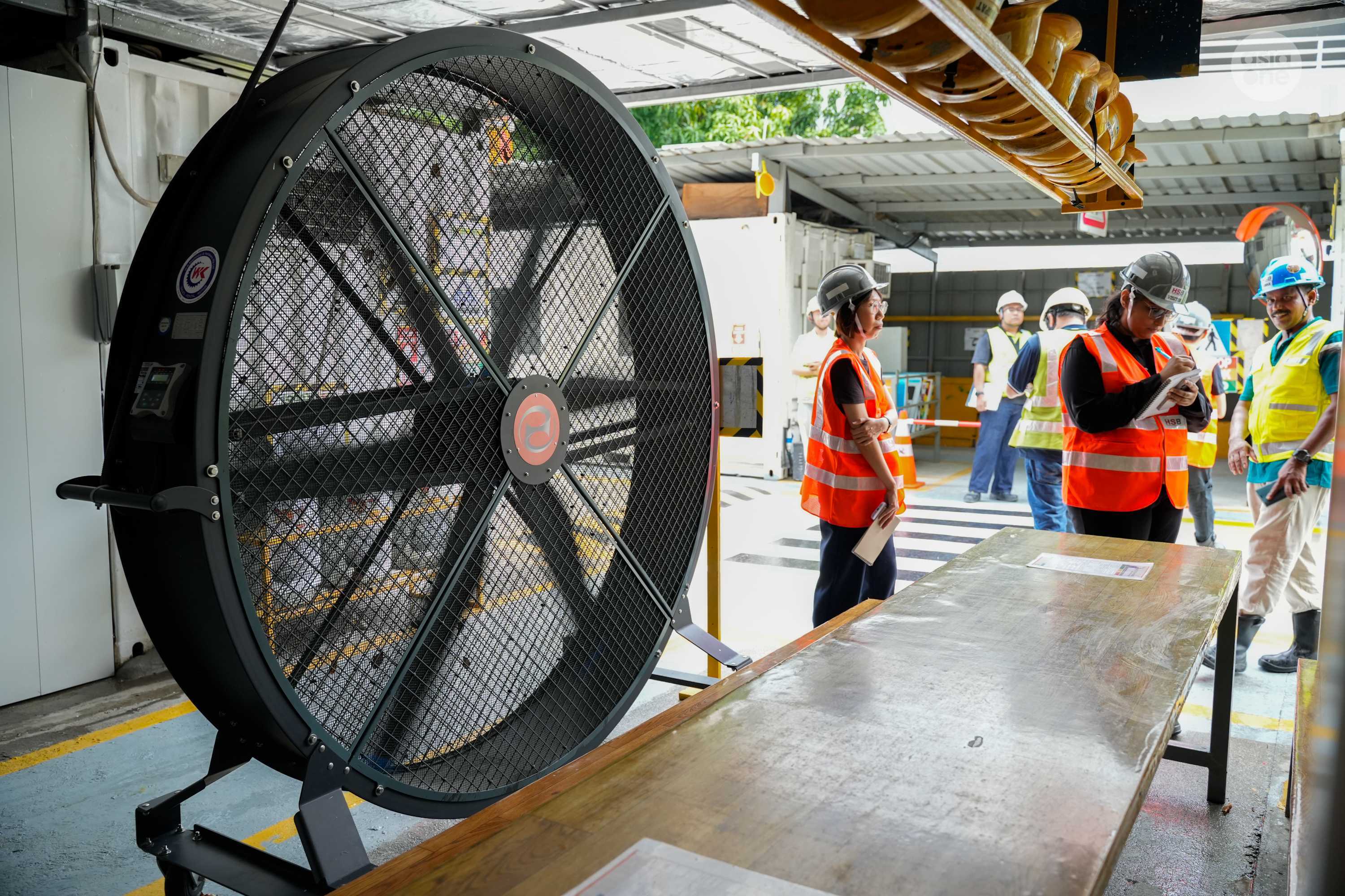 Industrial fans are deployed at resting areas to keep workers cool.