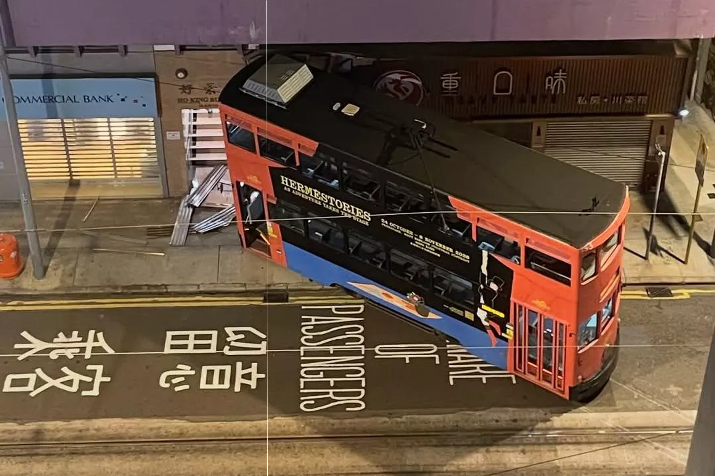 The derailed tram is seen lodged into the front of a restaurant along the street.
