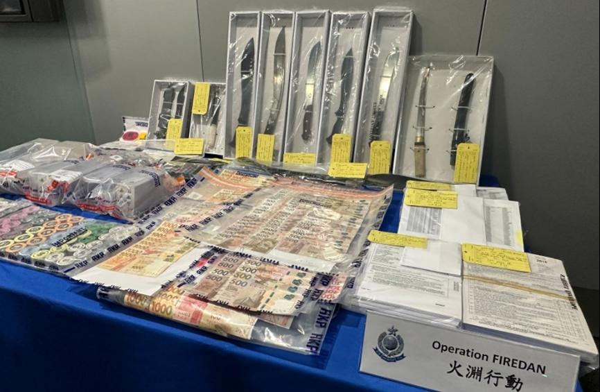 Exhibits showing some of the cash and items seized during the operation.