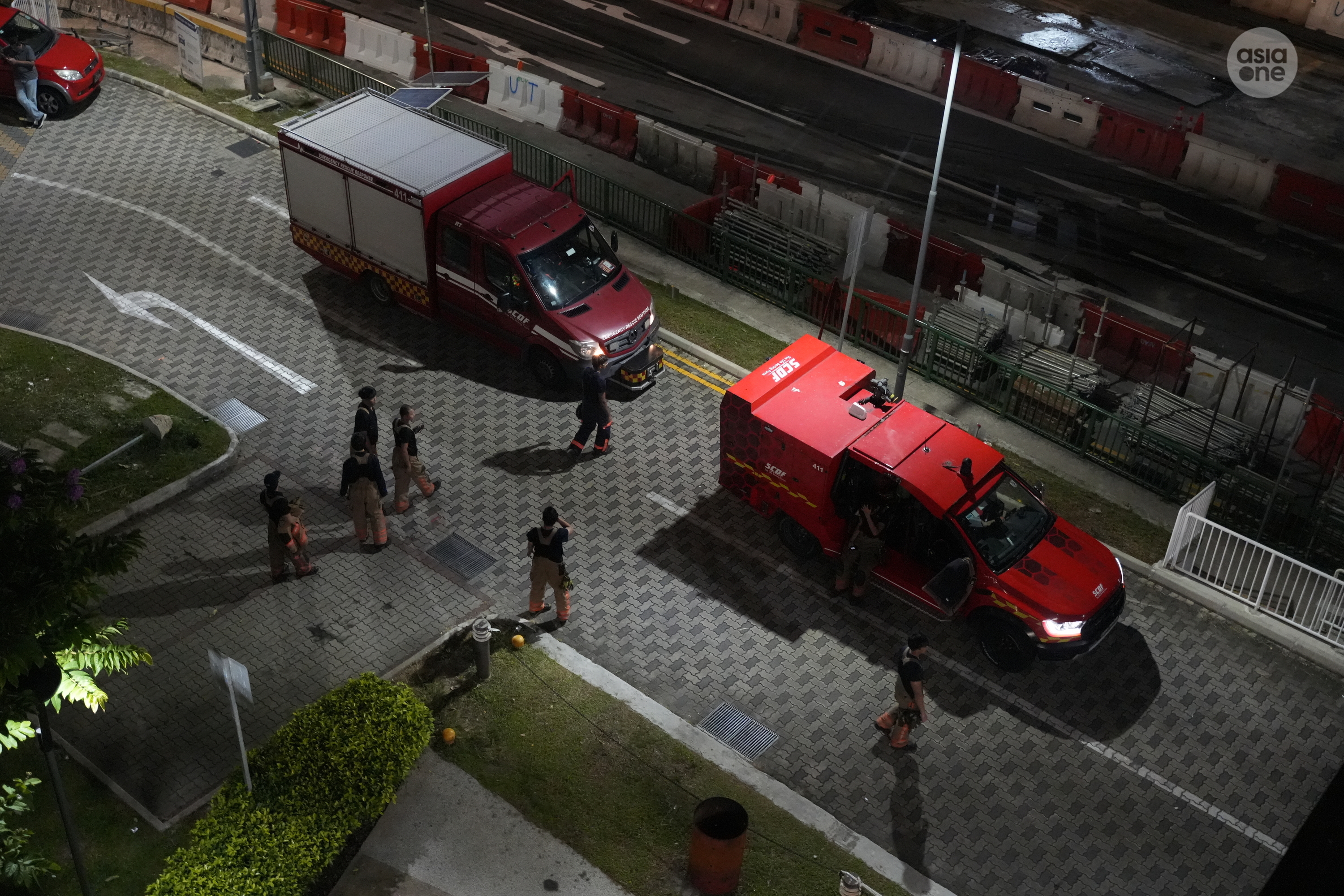 A Singapore Civil Defence Force light fire attack vehicle and a support vehicle (back) used by DART officers parked along the estate's driveway.