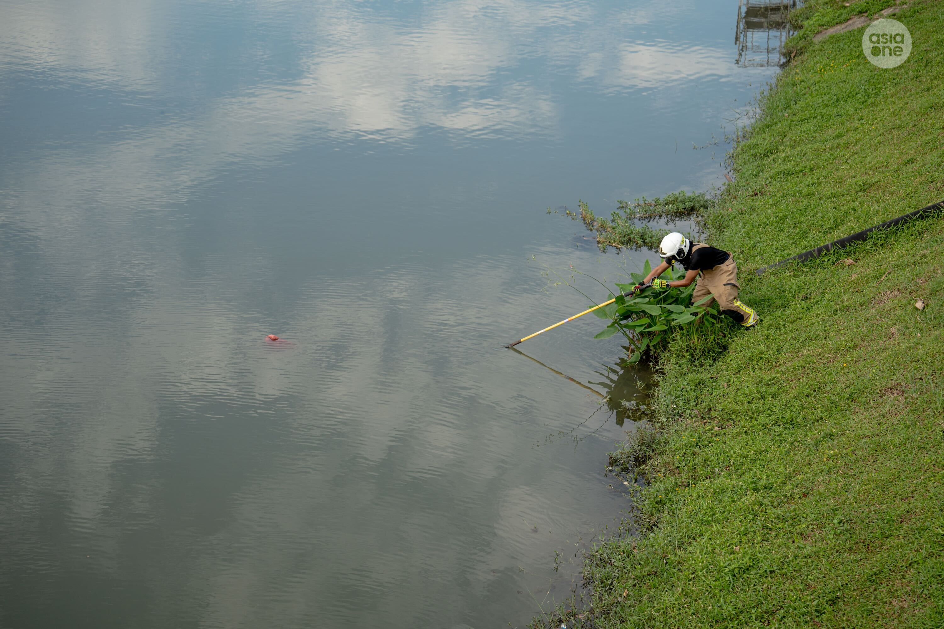An SCDF officer investigating the floating object.