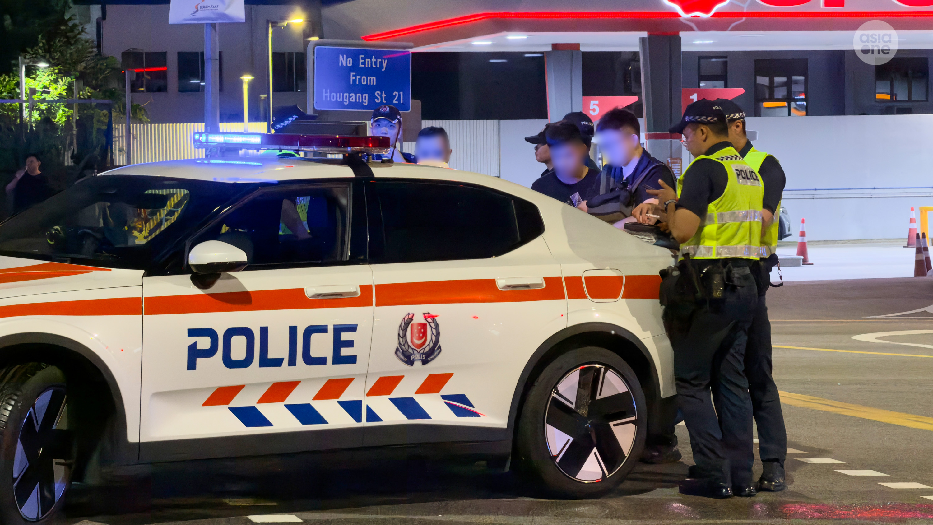 Police officers doing a search on the man moments before arresting him.