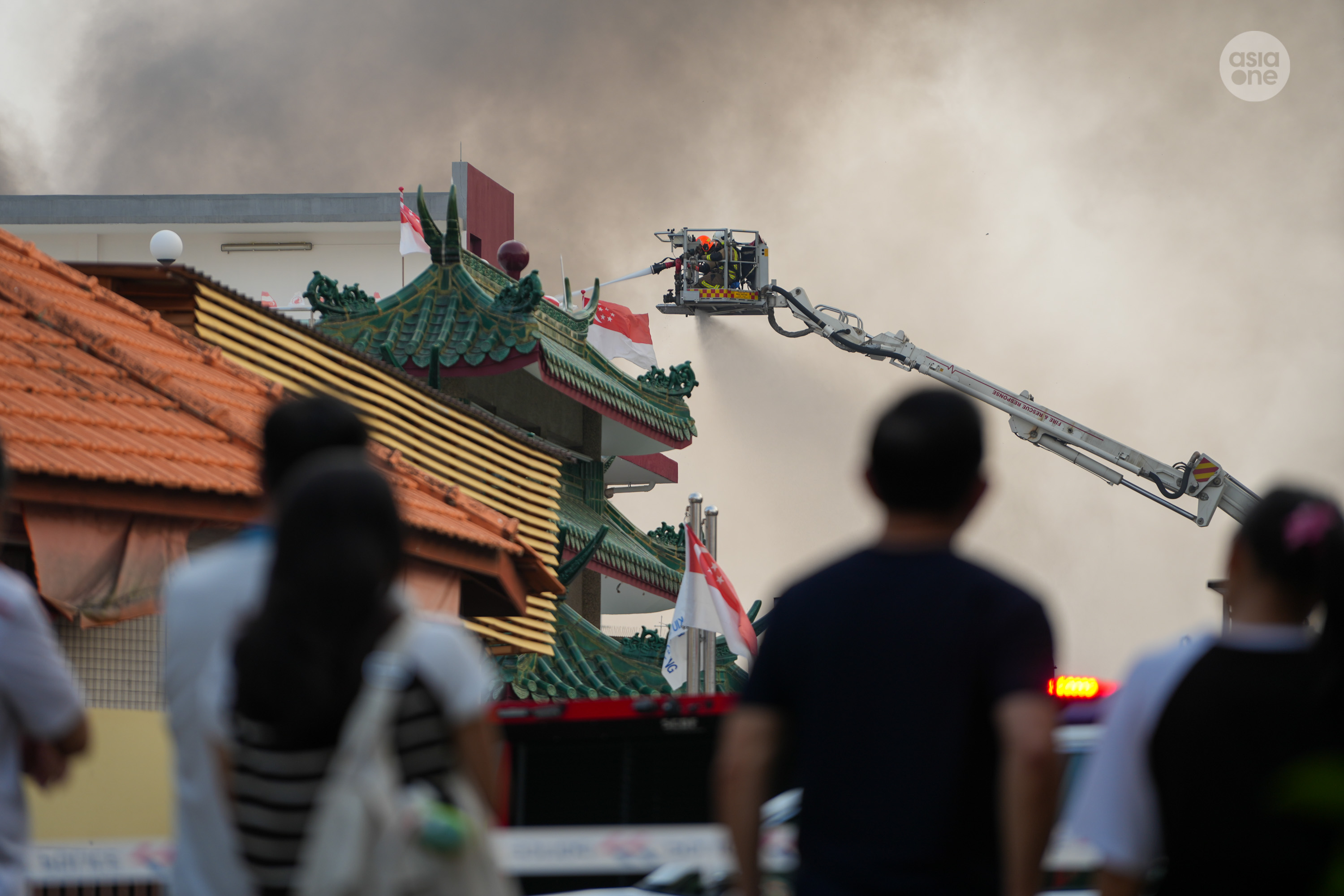 Firefighters conducting aerial firefighting using a combined platform ladder.