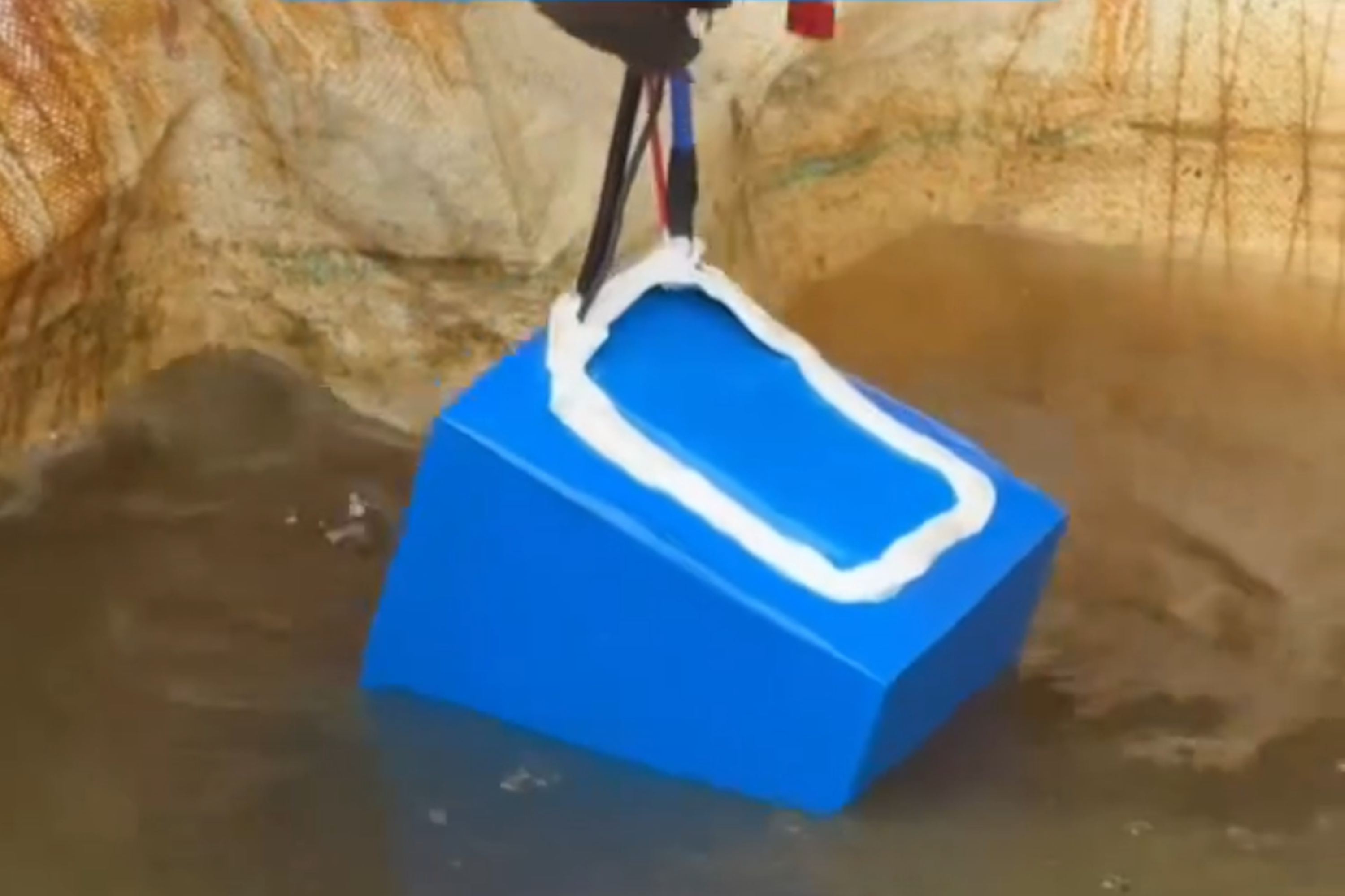 Removed batteries are placed in saltwater to discharge its stored energy before safe disposal.