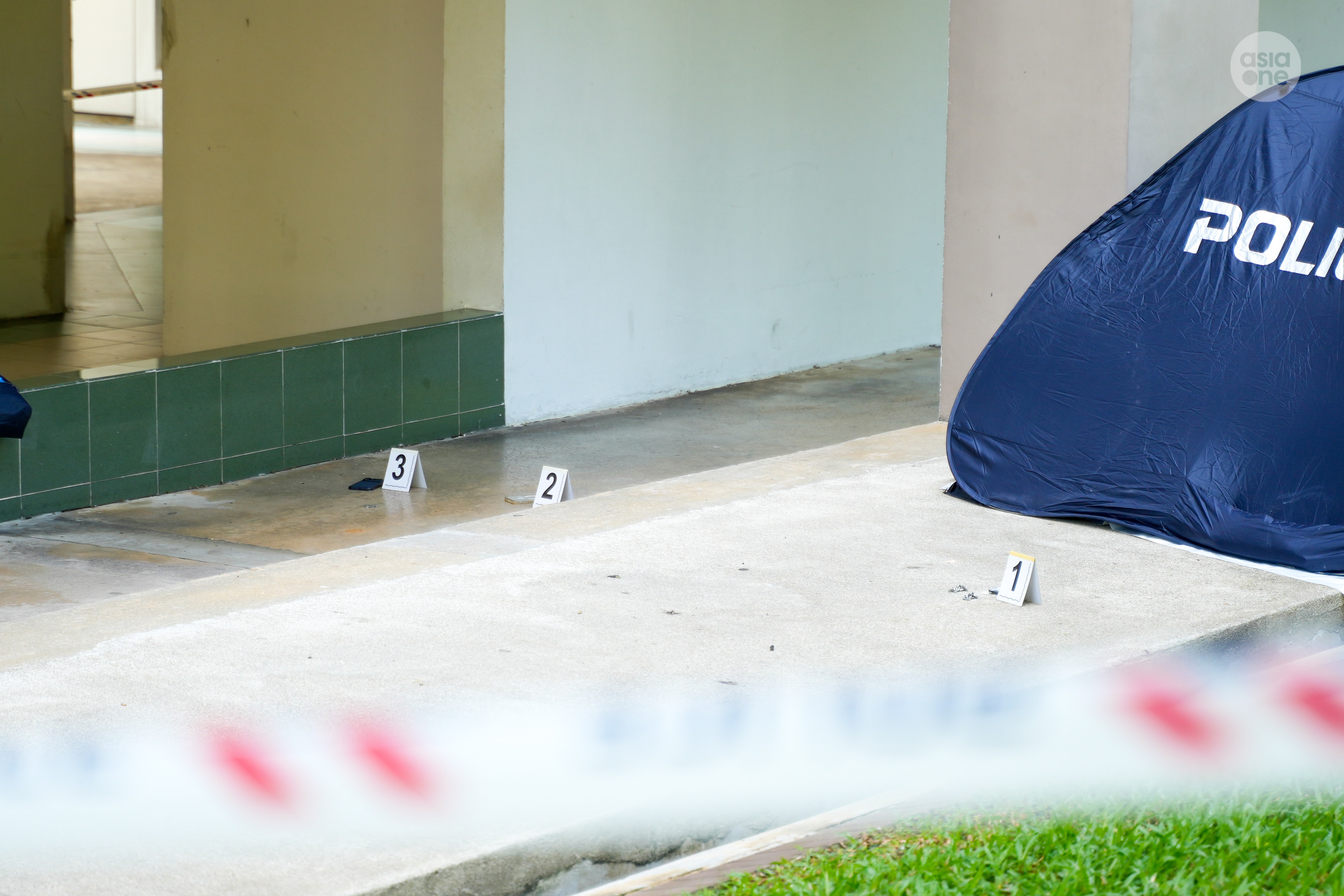 Evidence markers placed around items found near the man's body.