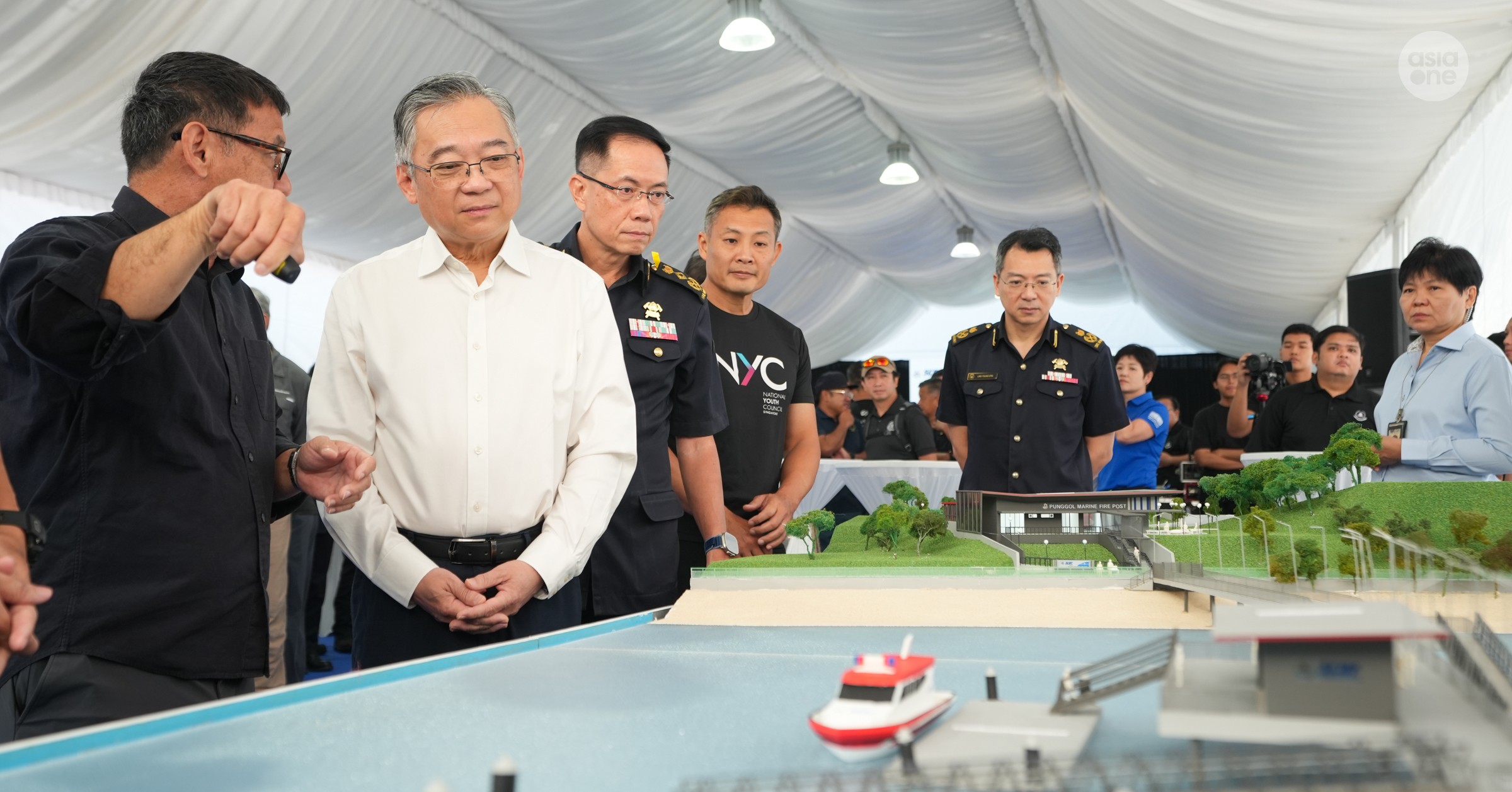 DPM Gan receiving a briefing on the features of the new Punggol Marine Fire Post.