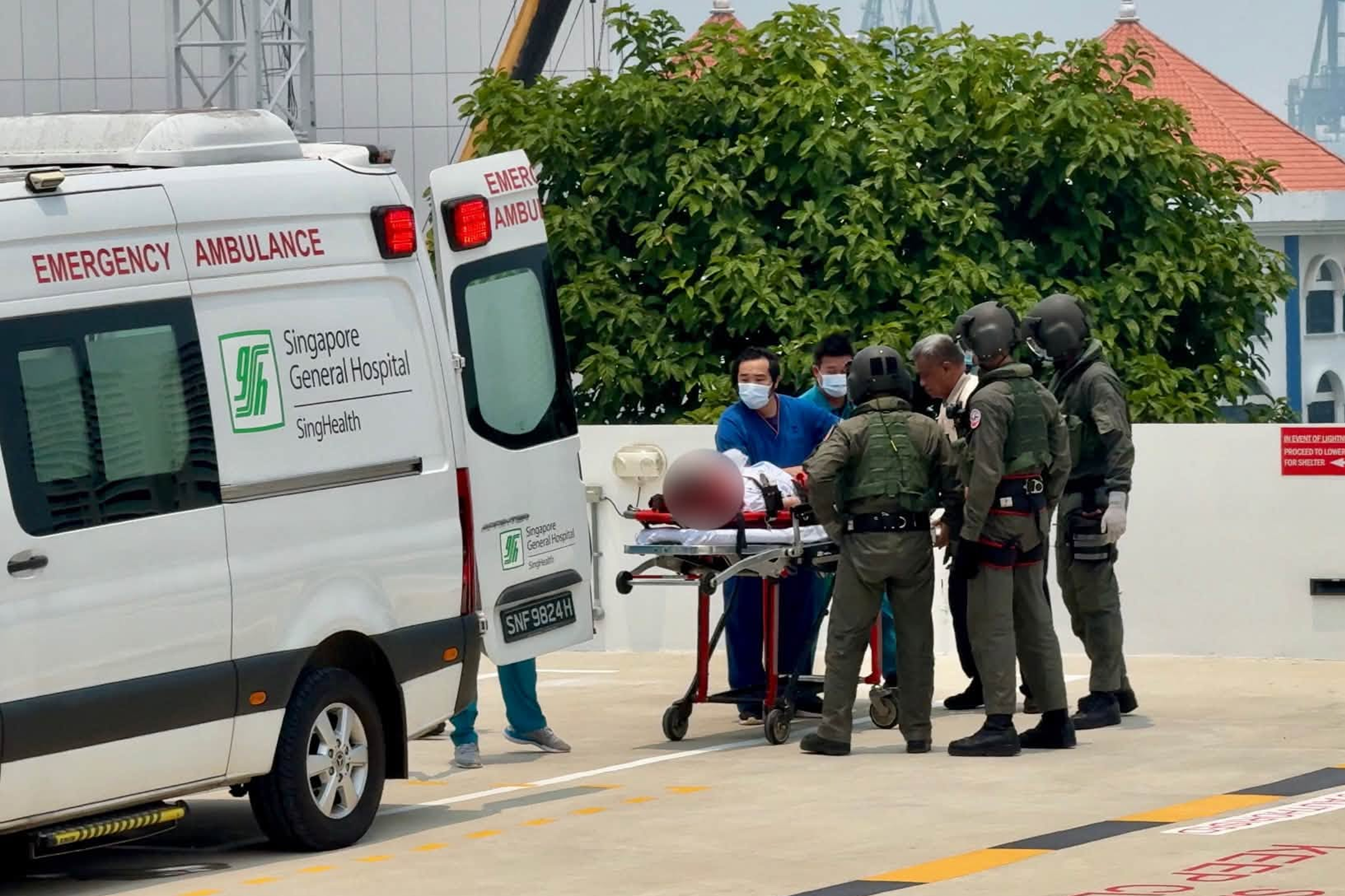 RSAF personnel transferring the patient to SGH medical staff.