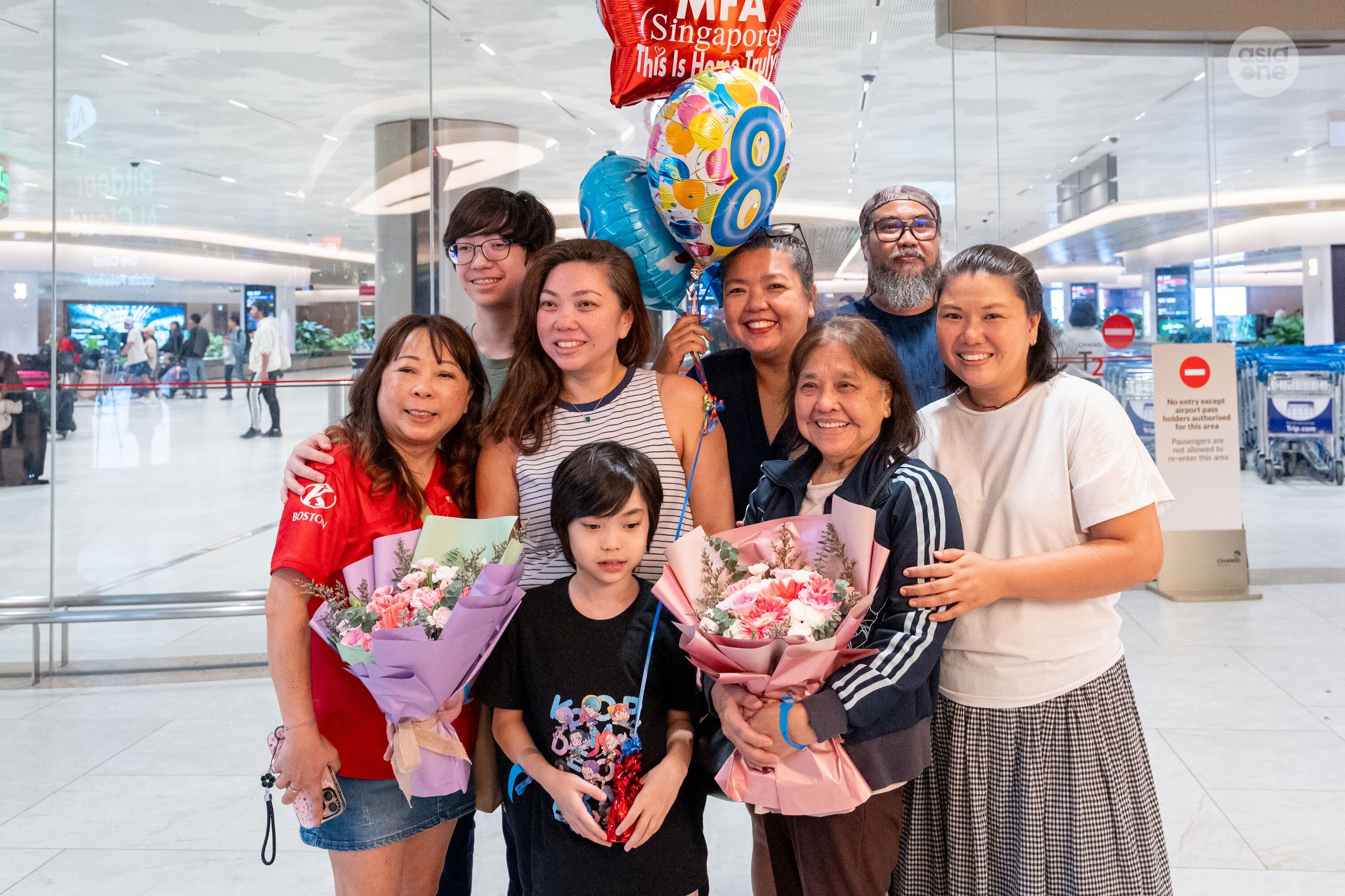 Samantha Merman (second from left, front row), 44 and her family.