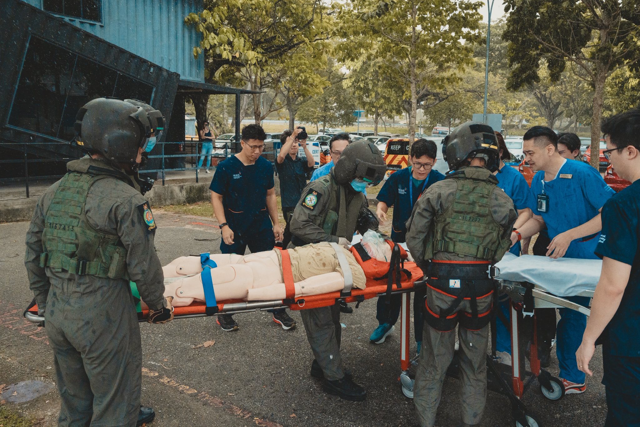 A medical team from NUH taking off the "patient" from the RSAF's aviation medical team.