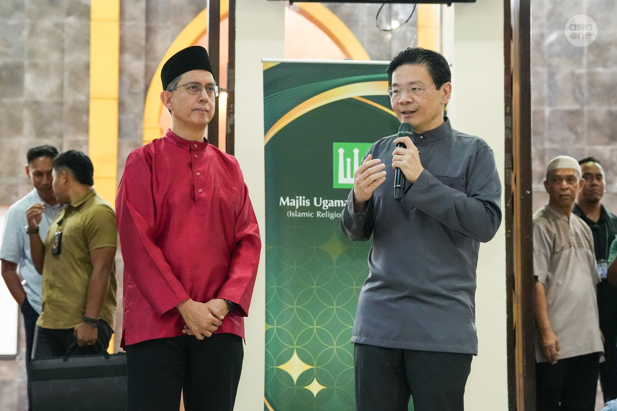 Prime Minister Lawrence Wong and Acting Minister-in-Charge of Muslim Affairs Assoc Prof Faishal Ibrahim greeting congregants at An-Nahdhah mosque in Bishan on Tuesday (Feb 18) evening.