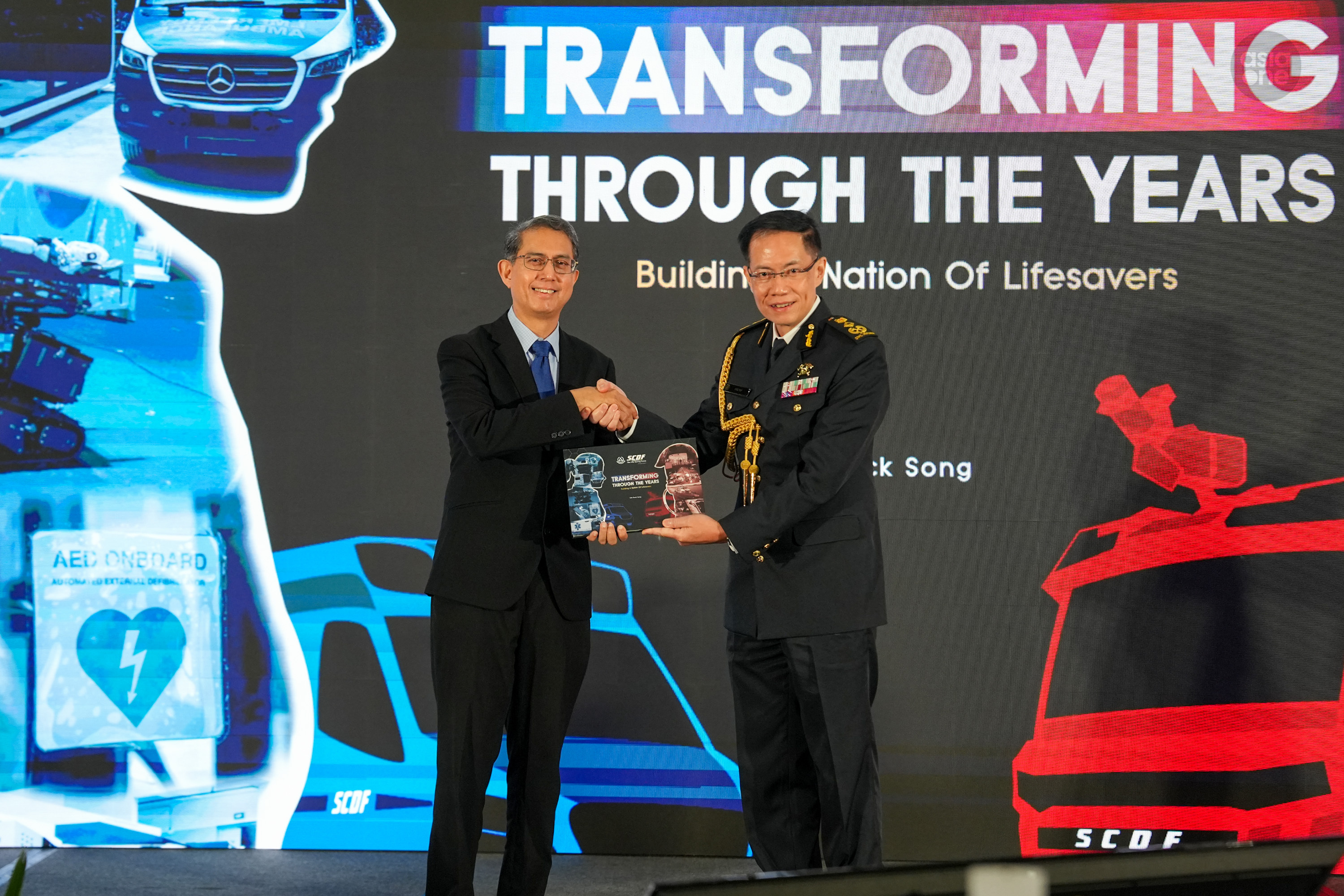 Senior Minister of State for Home Affairs Assoc Prof Muhammad Faishal Ibrahim launching the SCDF's new transformation book. 