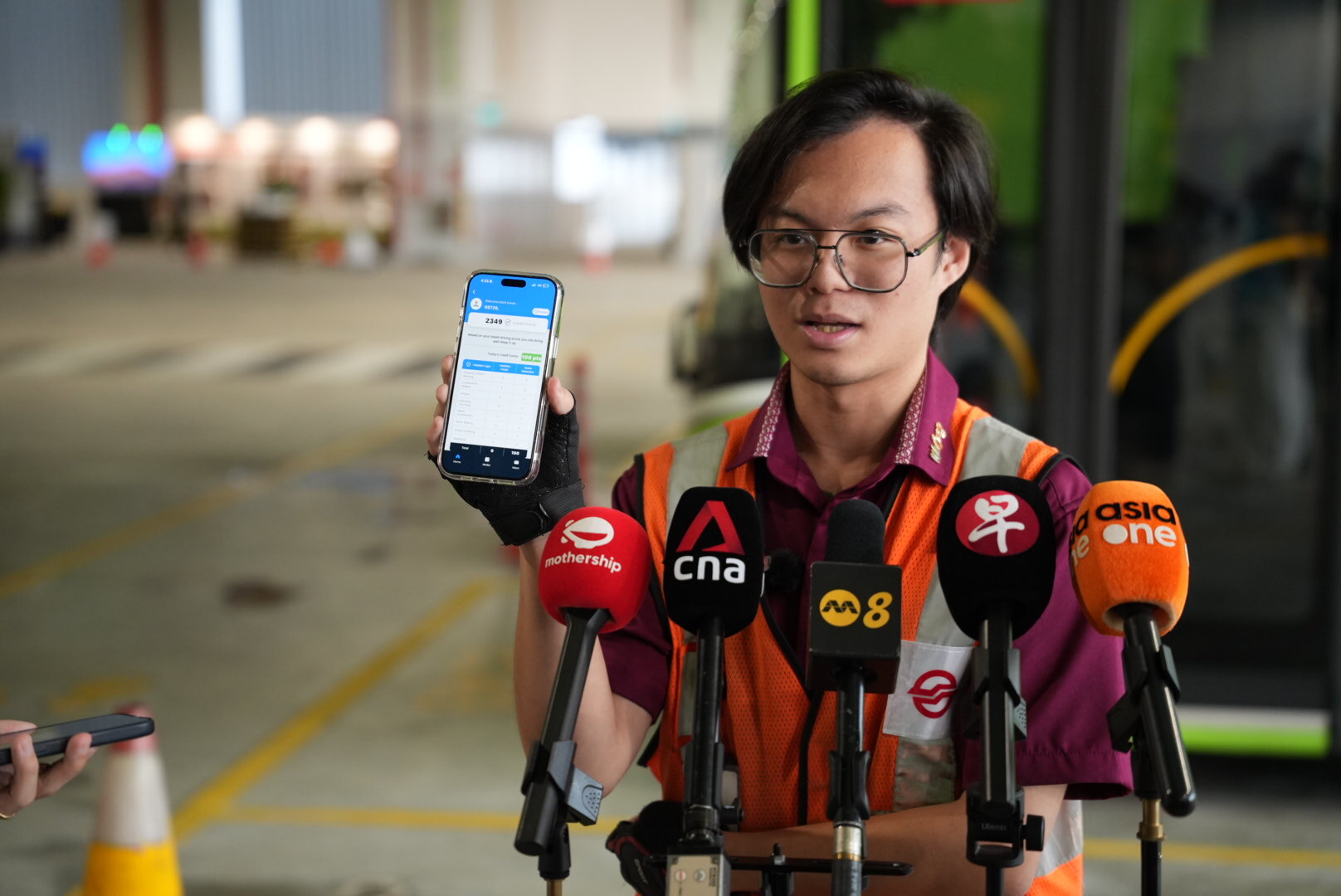 SMRT Bus's youngest bus captain, Jayrius Ong, 23, showing the media how his safety records have improved with the Bus Captain Management System. 