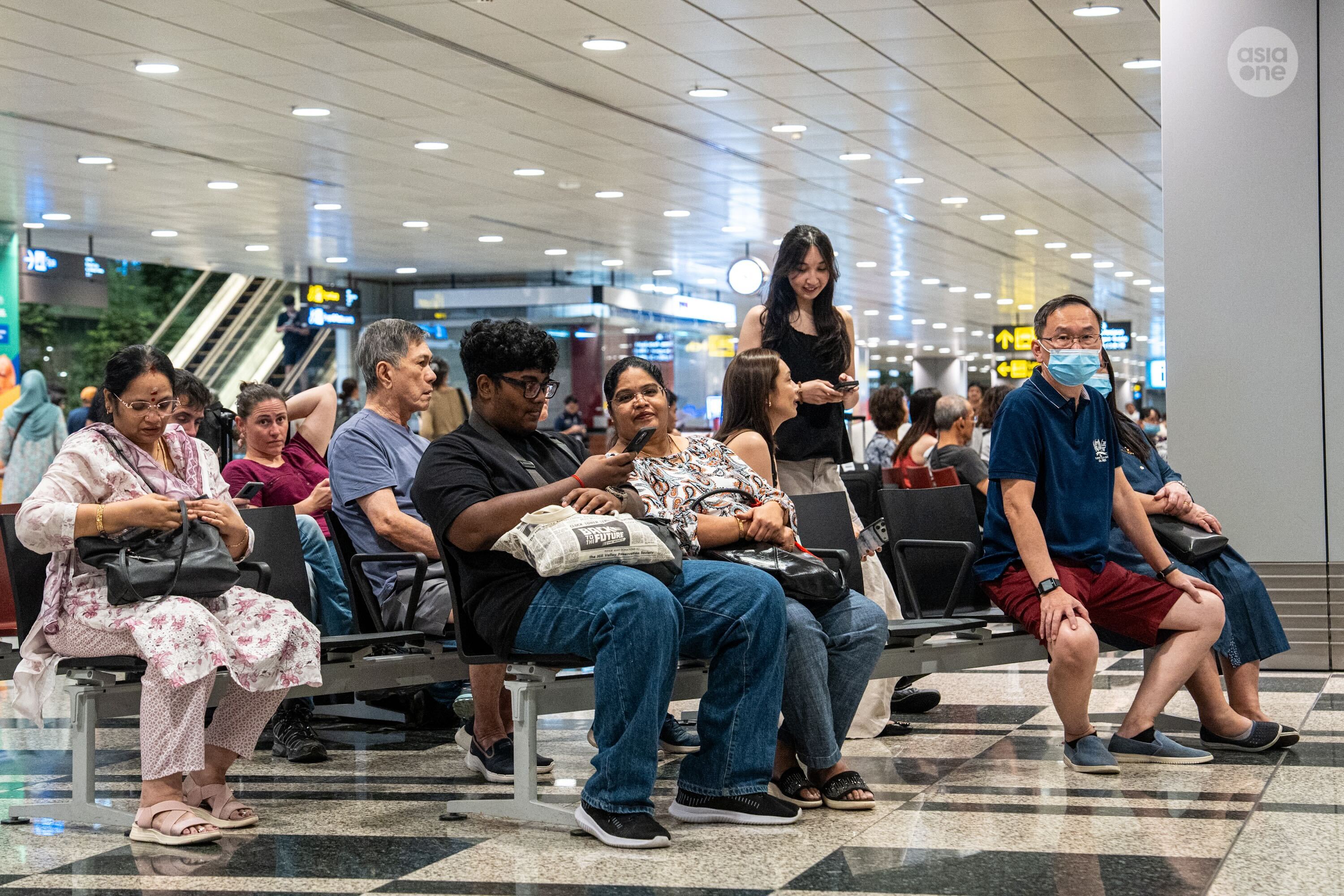 Families and friends of Singaporeans and their dependents onboard Singapore Airlines flight SQ8001 waiting for their arrival at Changi Airport Terminal 3 on Saturday (March 7) night.
