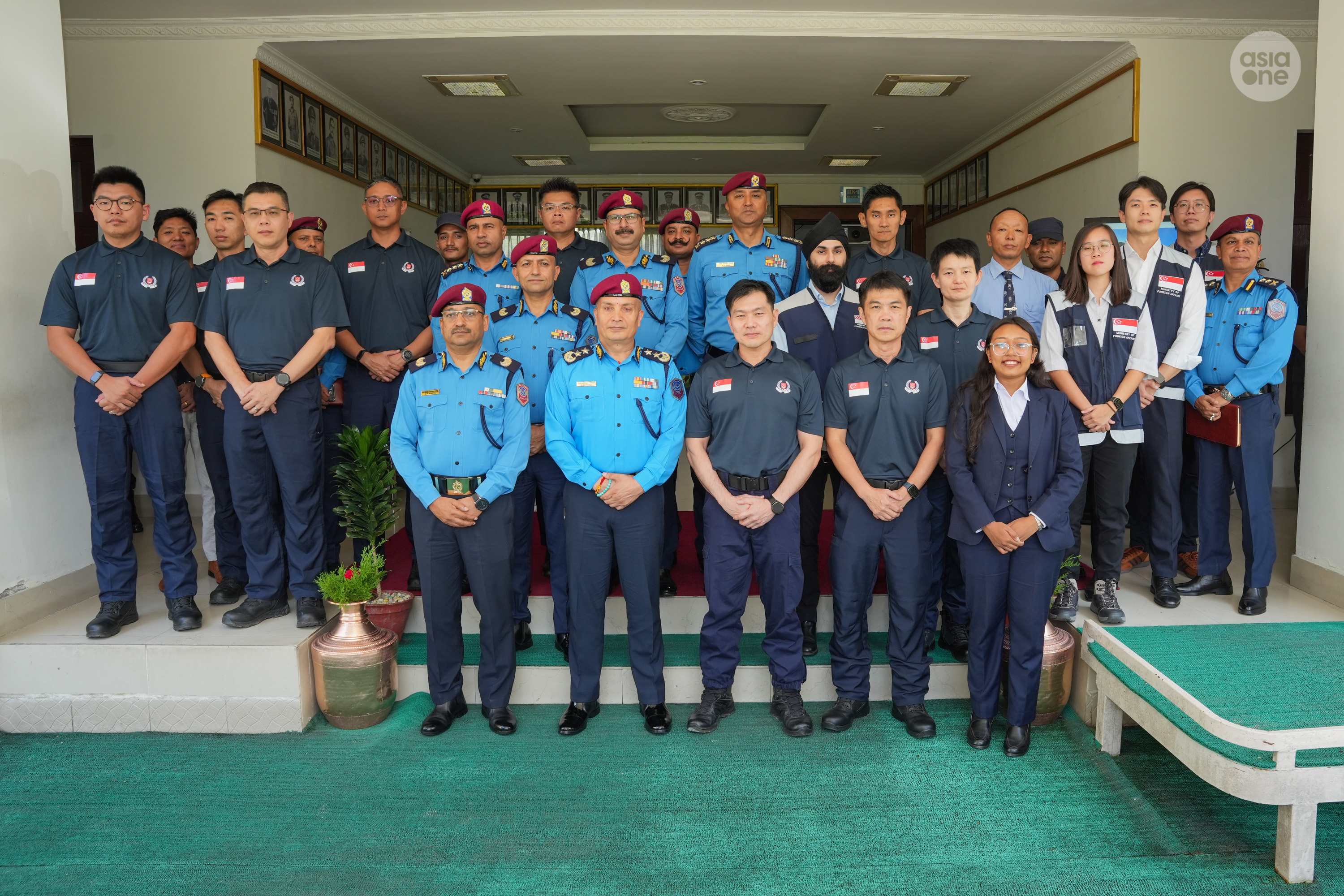 AC Patrick Tan (front row, third from left) and IGP Karki (front row, 2nd from left) and officers from the Singapore Police Force and Nepal Police, along with Crisis Response Team officers from Singapore's Ministry of Foreign Affairs pose for a group shot after the handover.