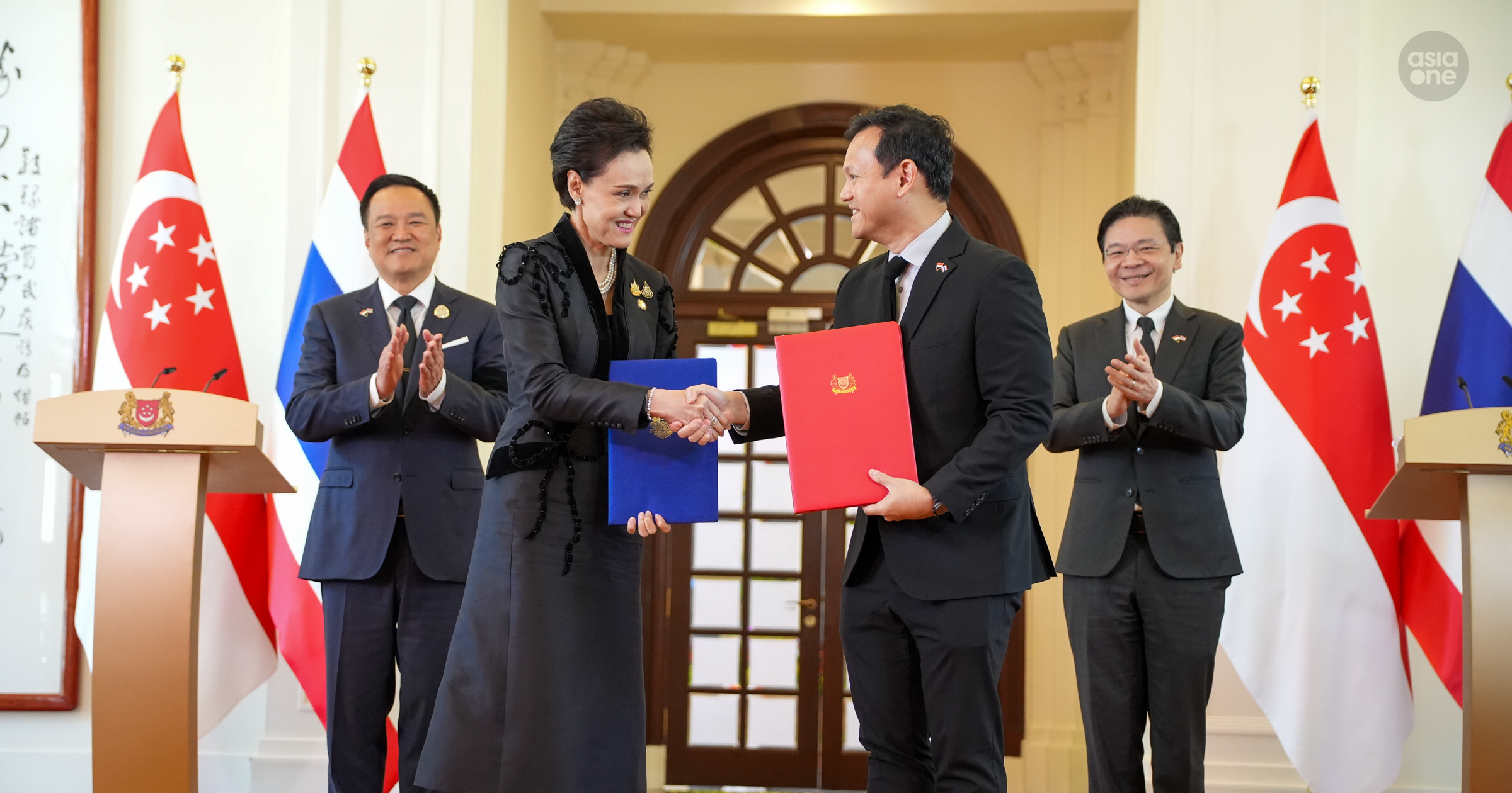 Thailand's Minister for Commerce Suphajee Suthumpun exchanging the memoranda of cooperation on rice trade with Senior Minister of State for Sustainability and the Environment Zaqy Mohamad on Friday (Nov 7).