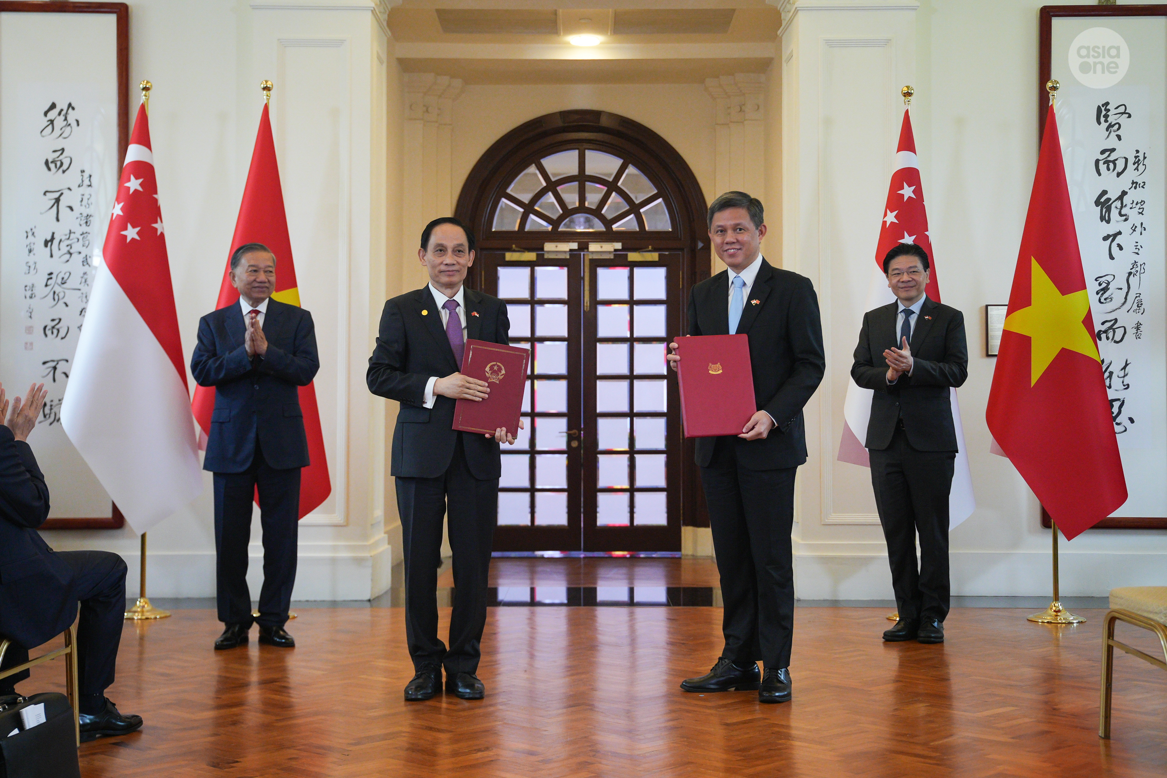 Coordinating Minister for Public Services Chan Chun Sing (right) with Vietnam's Minister of Foreign Affairs Le Hoai Trung exchanging the memorandum of understanding on cooperation for the Singapore-Vietnam Strategic Dialogue.