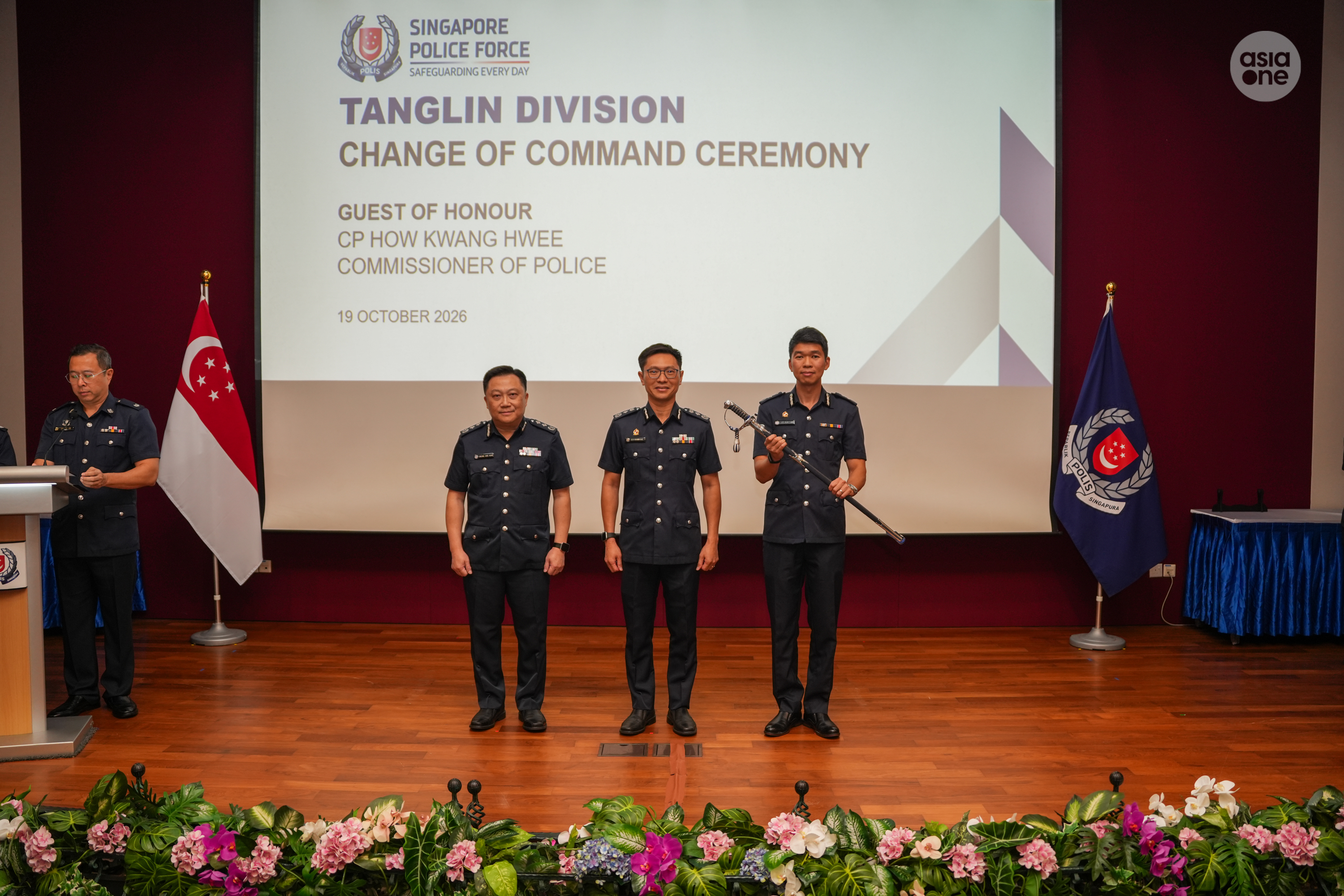 SAC Lee Huan Ting (right, with symbol of command) in a group photo with outgoing Tanglin Police Division commander SAC Cheong Chee Meng (left) and Commissioner of Police How Kwang Hwee (middle) at the change of command ceremony on Oct 19. 