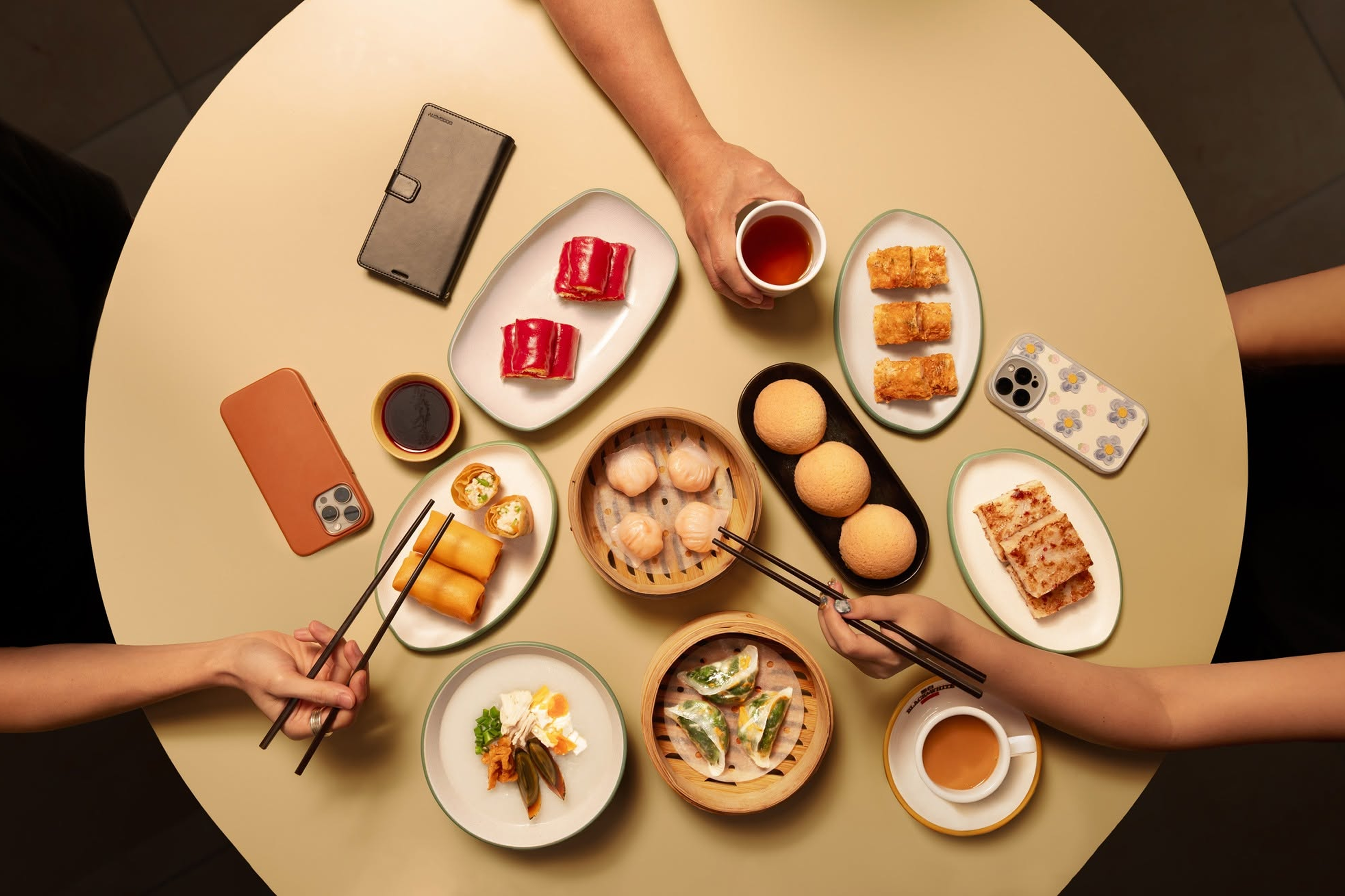 An assortment of Tim Ho Wan's dim sum, including its popular baked bun with barbeque pork (on black serving plate).