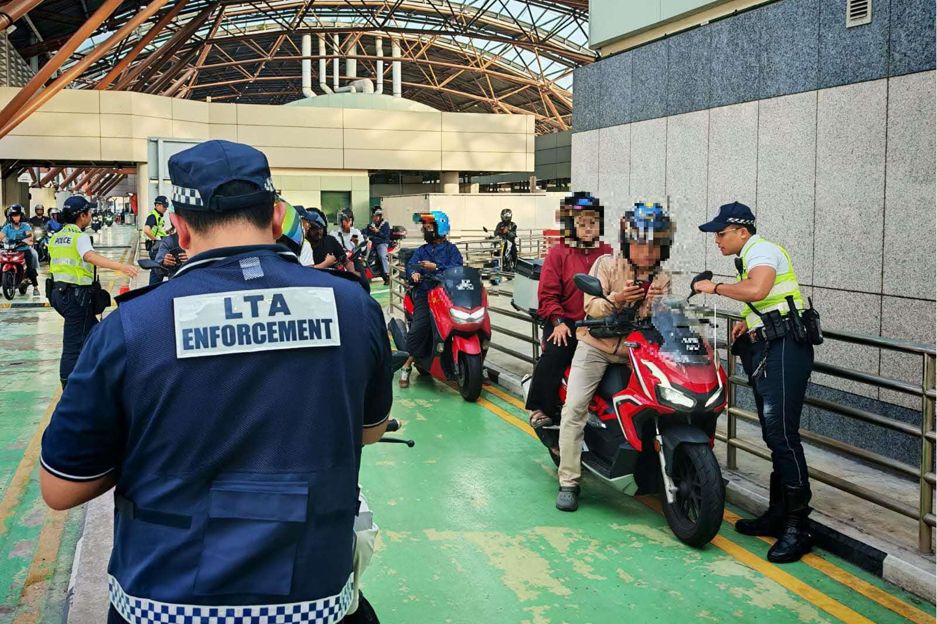 LTA officers conducting checks on motorcycles at Tuas Checkpoint on May 12.