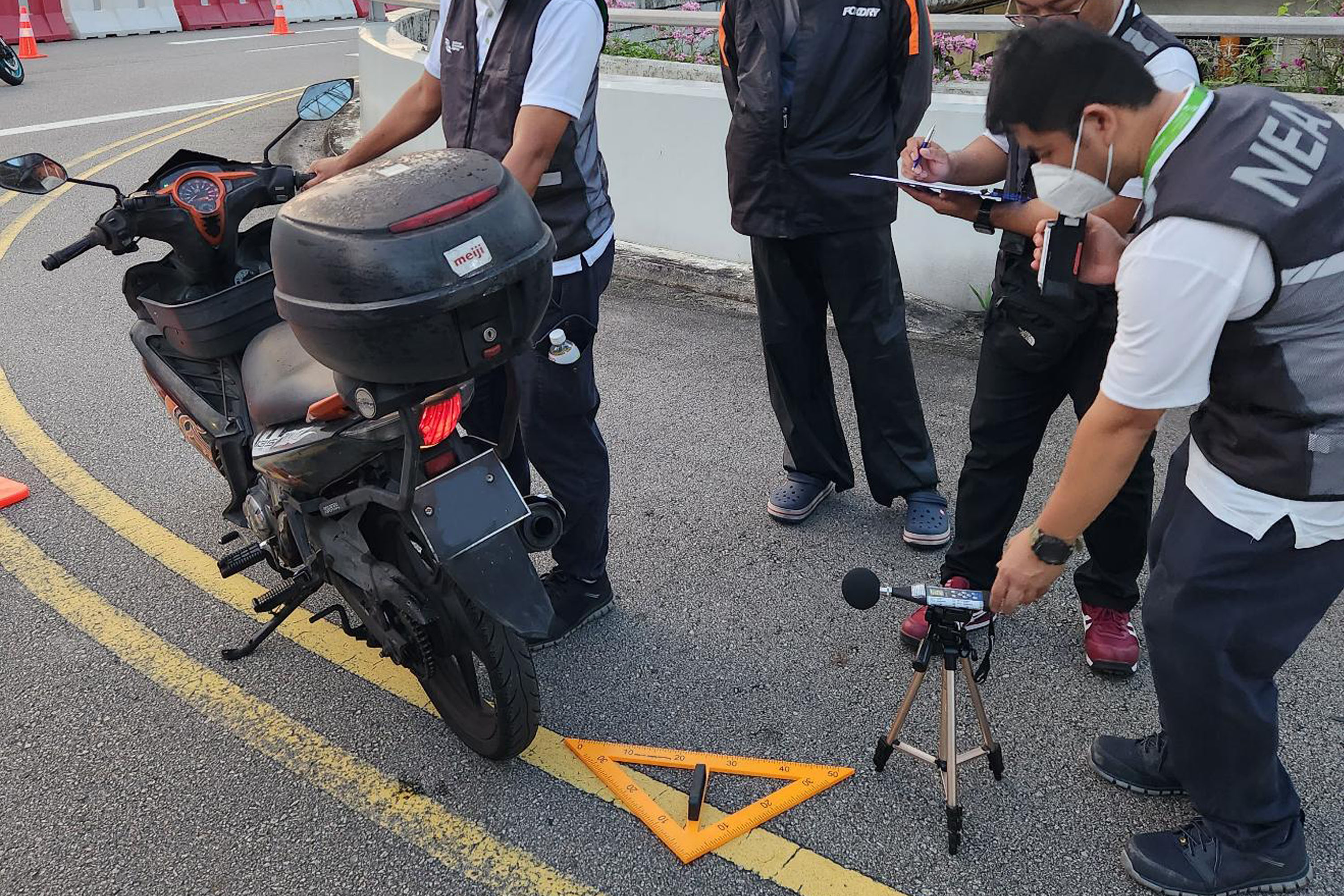 NEA officers conducting checks on a motorcycle at Tuas Checkpoint on May 12.