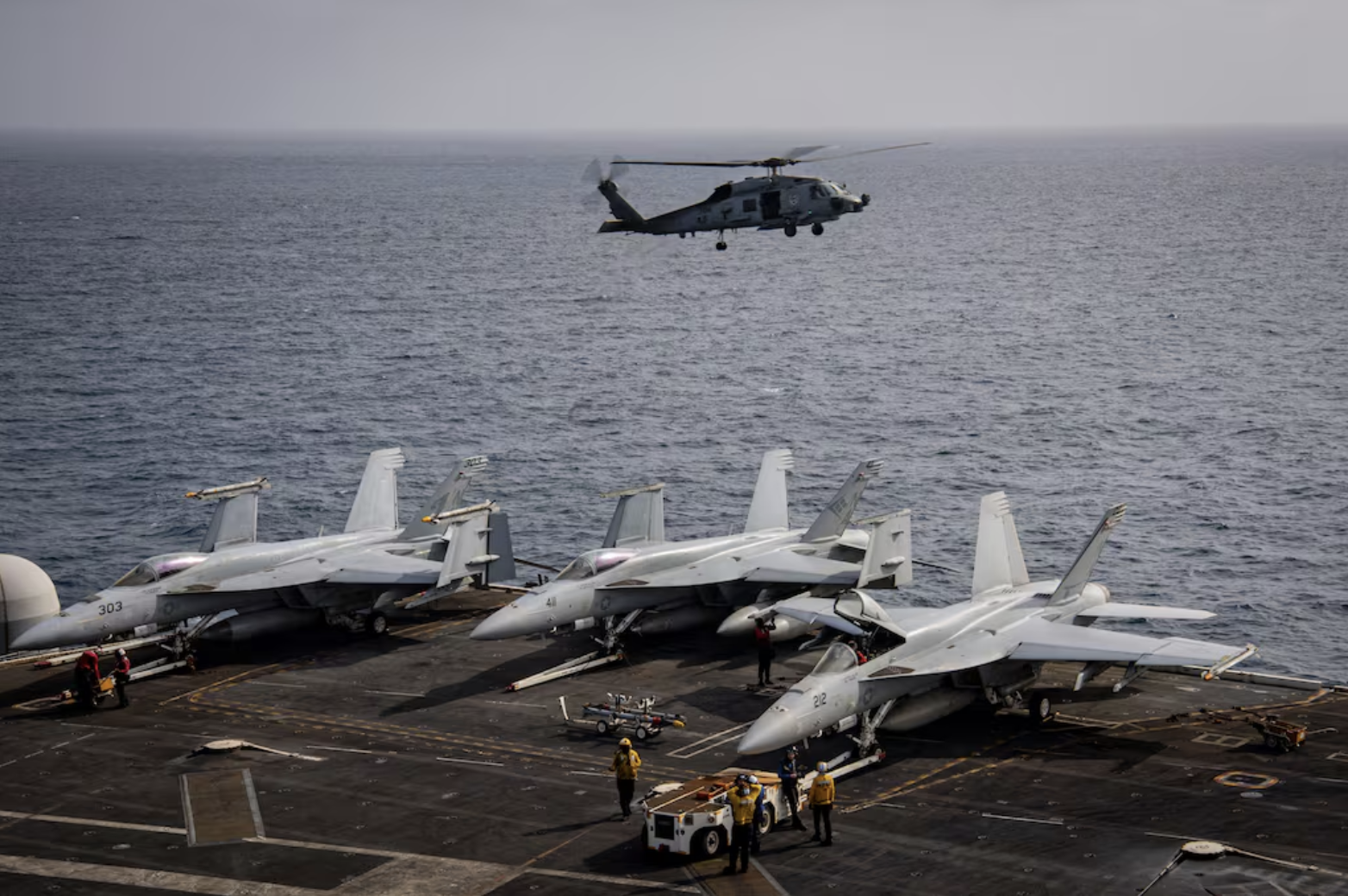 A MH-60R Seahawk naval helicopter taking off from USS Nimitz.