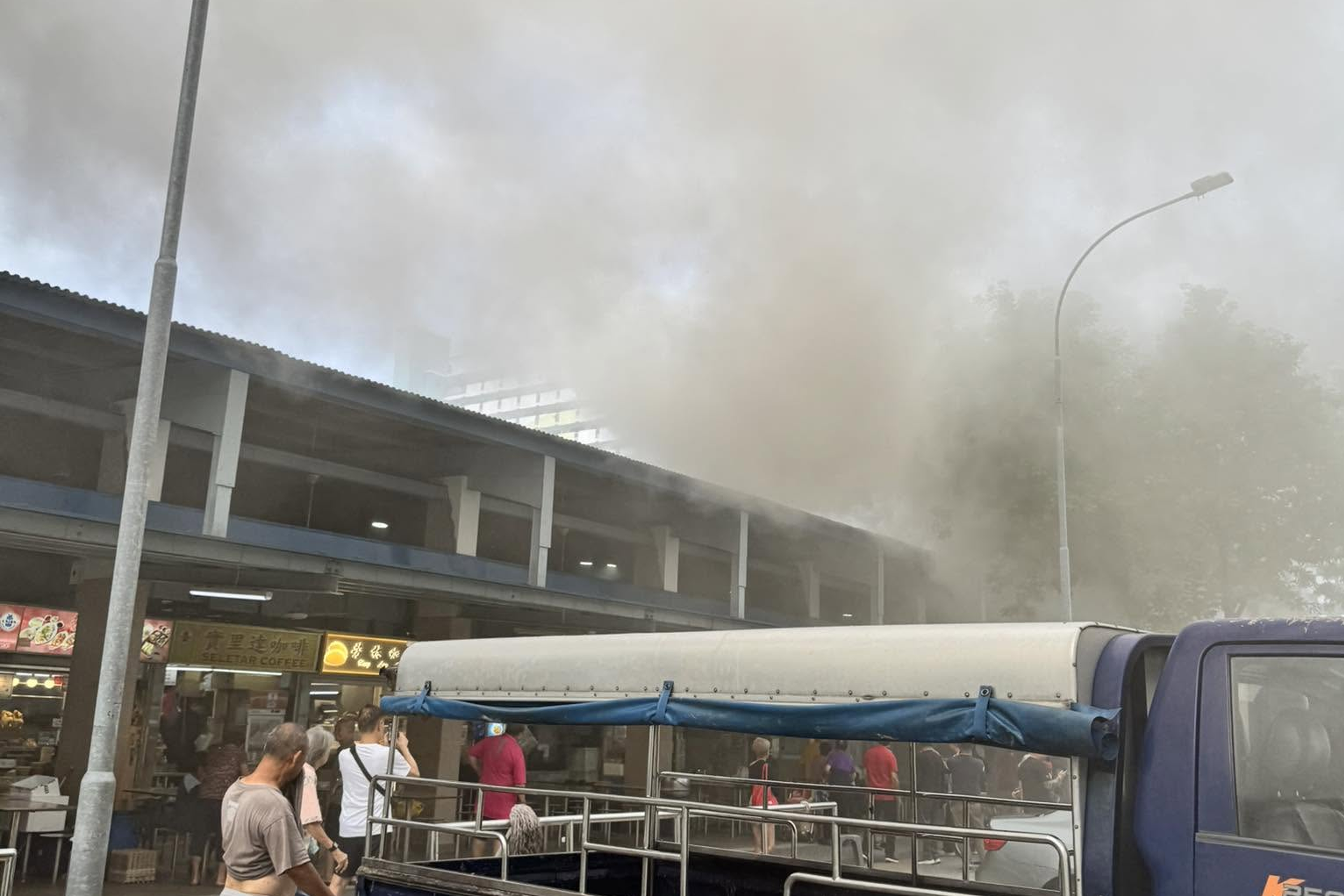 Thick smoke is seen billowing out of the food centre.