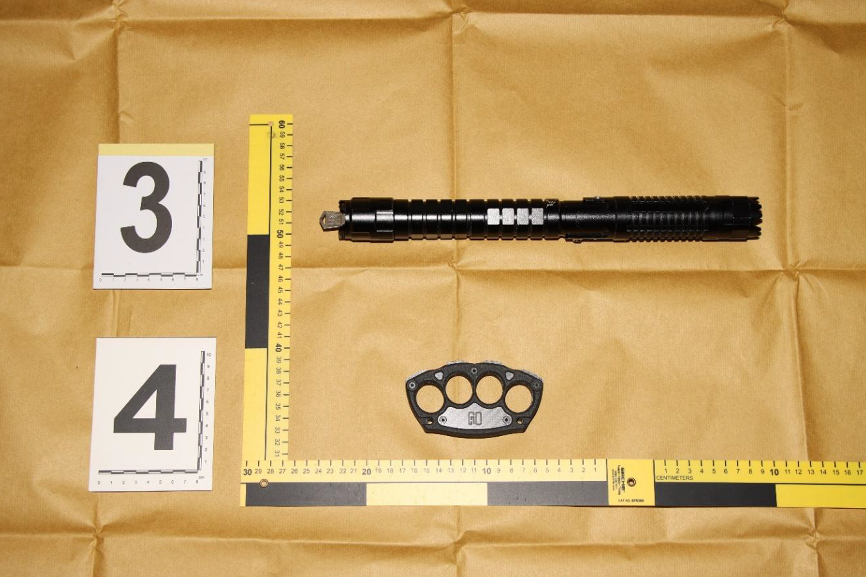 A suspected stun device and knuckle duster seized from the man's unit.