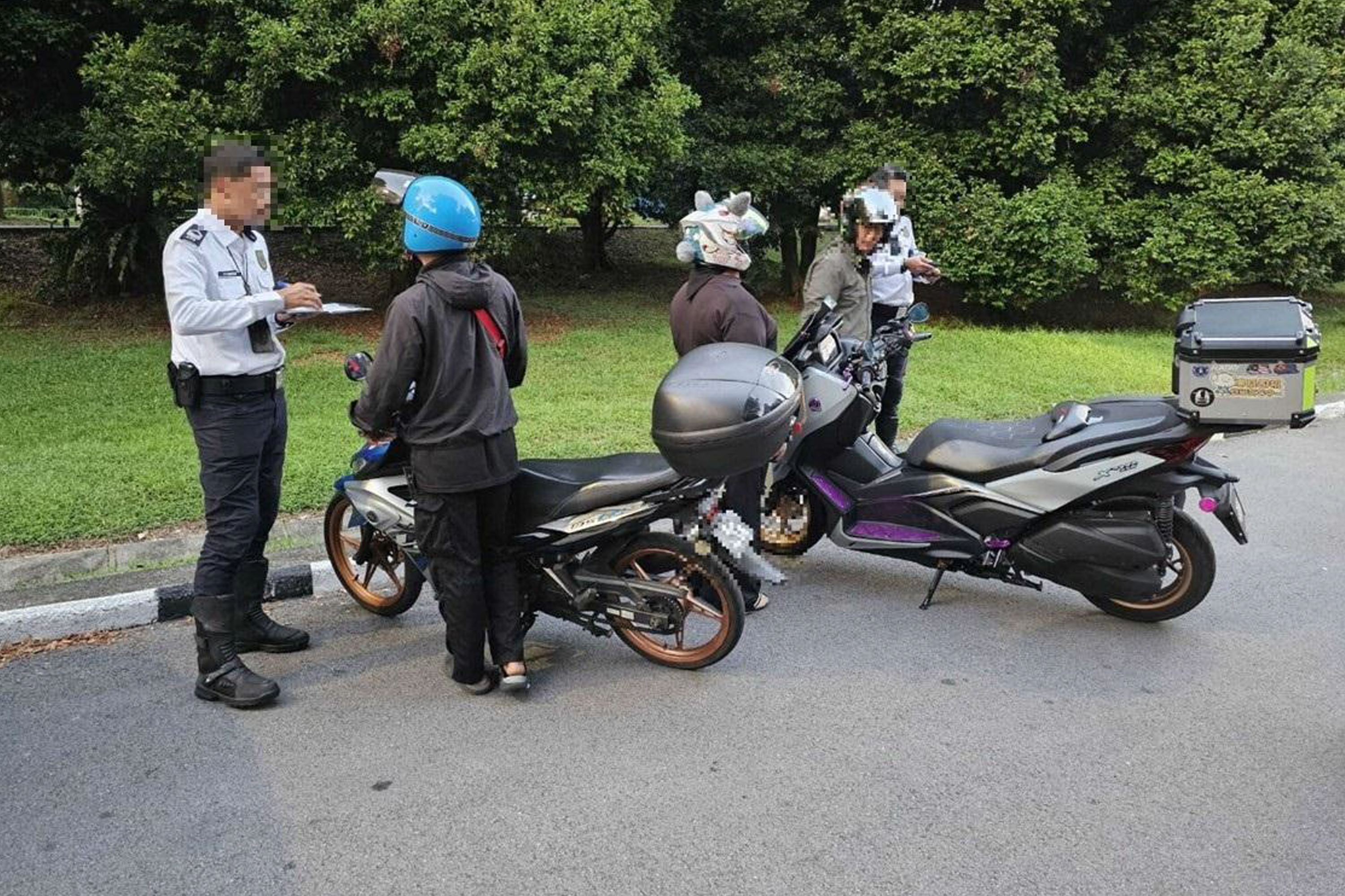 LTA officers conducting checks on motorcyclists.