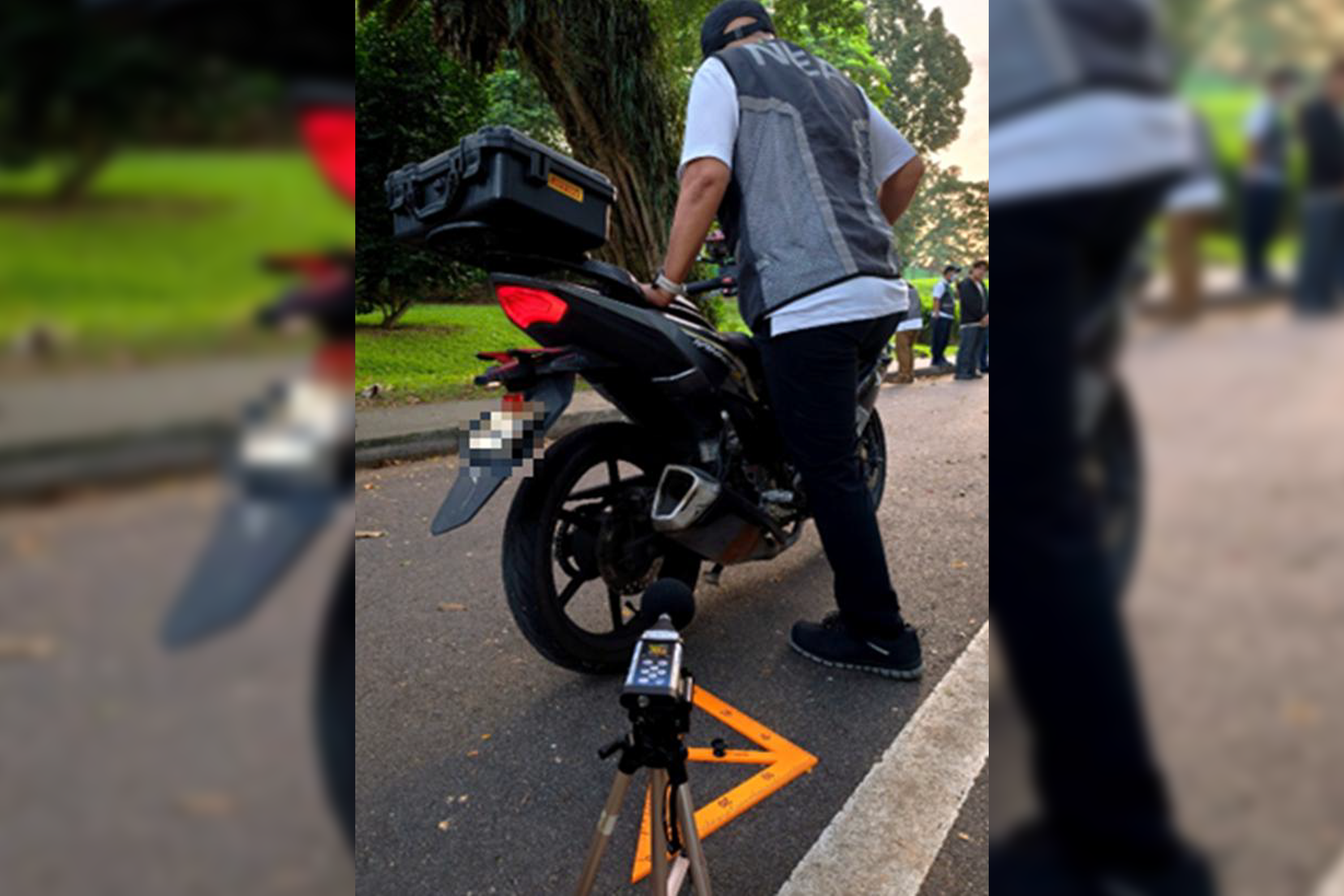 NEA officers conducting measurement for vehicular noise on a motorcycle.
