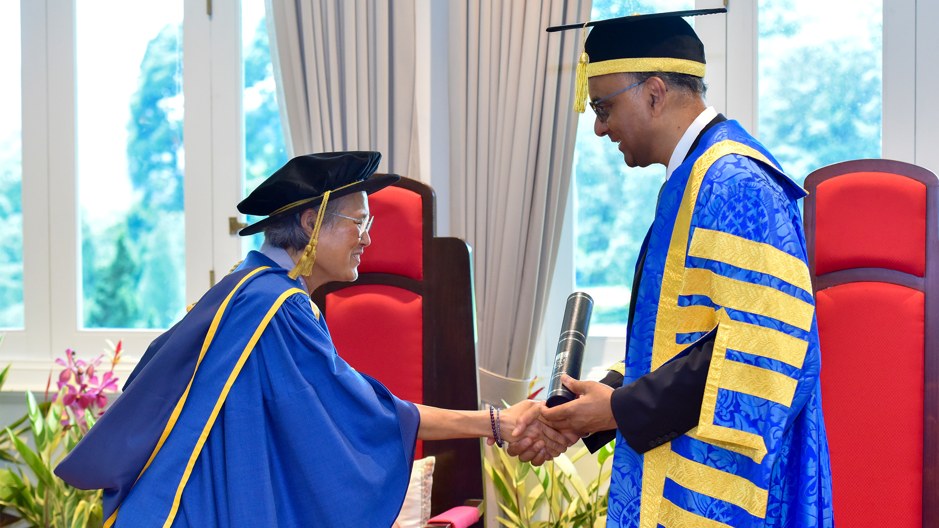President Tharman Shanmugaratnam conferring the Honorary Doctor of Letters on Her Royal Highness Princess Maha Chakri Sirindhorn (left) of the Kingdom of Thailand.