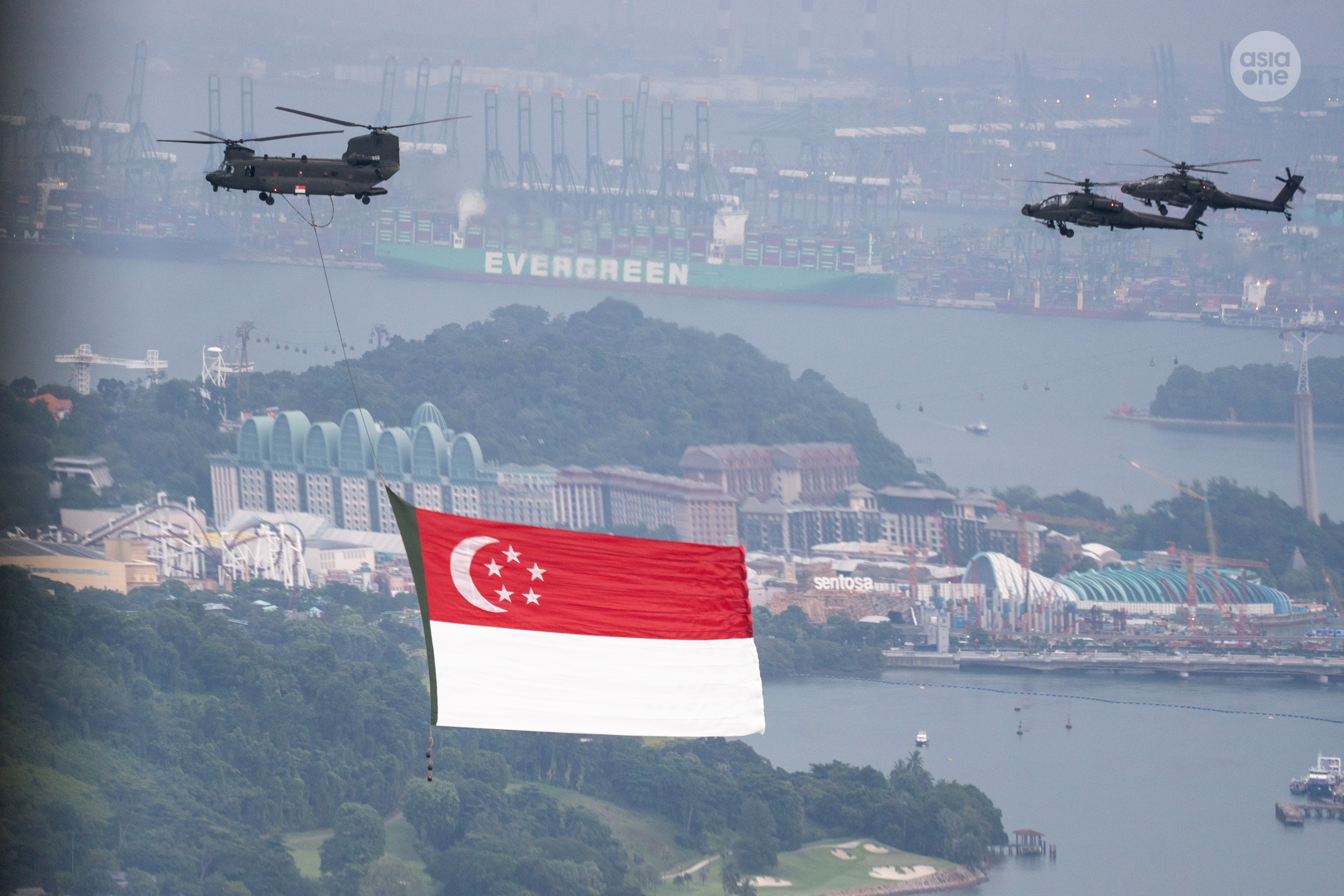 The CH-47 chinook, escorted by two AH-64D Apache helicopters flying in a V-formation during the combined rehearsal on July 4.