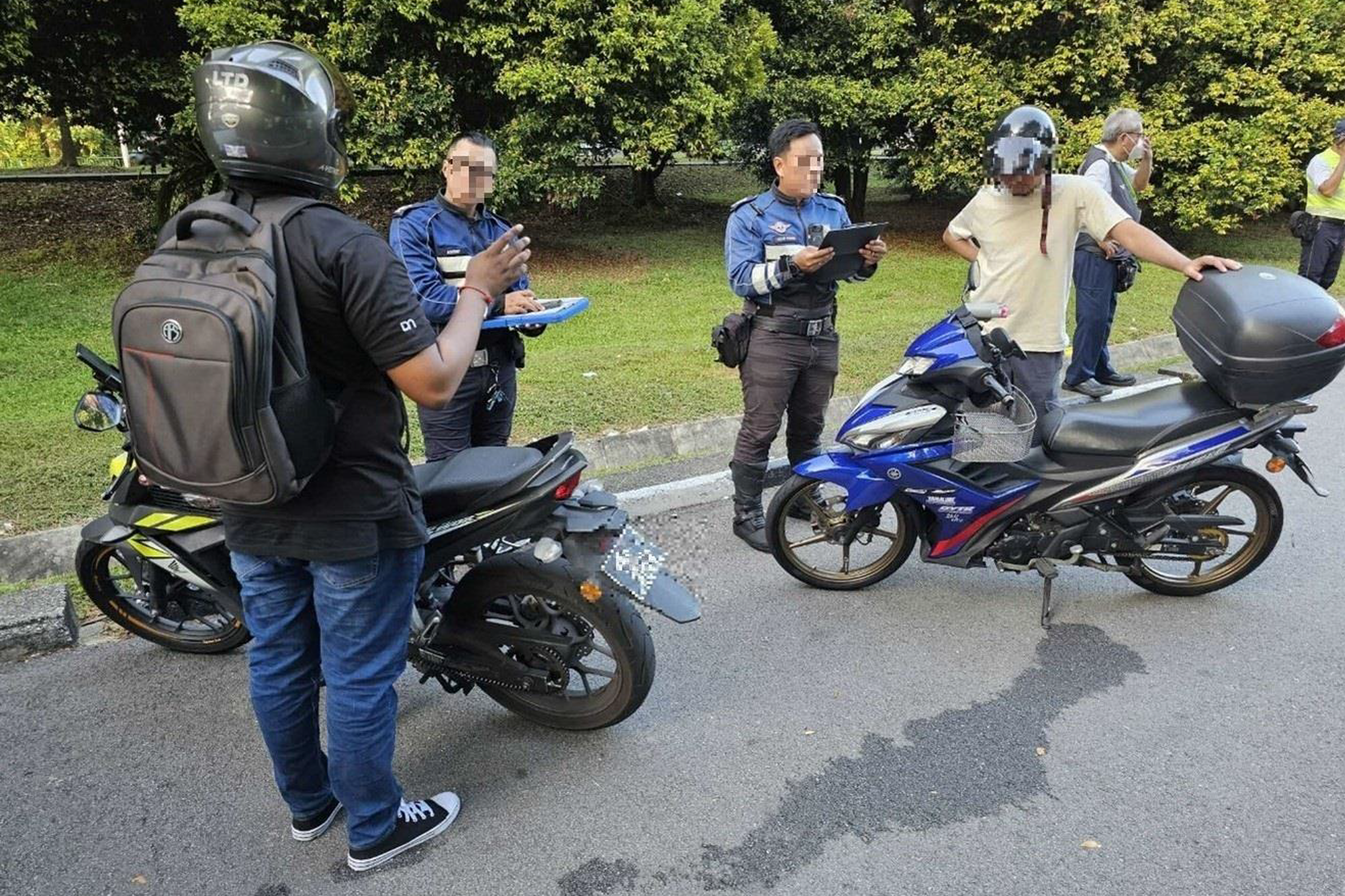 LTA officers conducting checks on motorcyclists along Admiralty Road West on June 29.