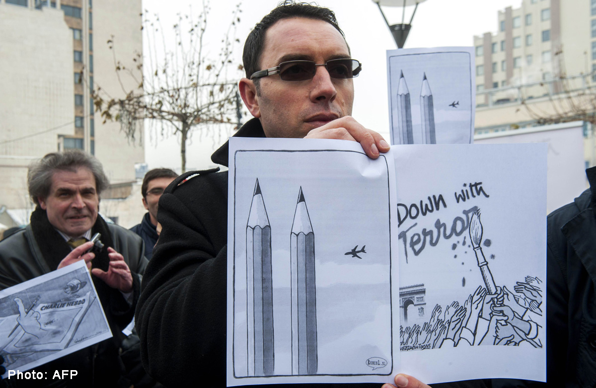 Scared But Defiant Cartoonists Raise Pencils To Charlie Hebdo World 
