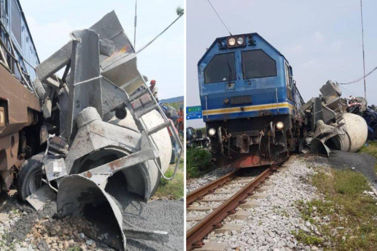 Driver escapes as train mows down cement mixer in Malaysia, Malaysia