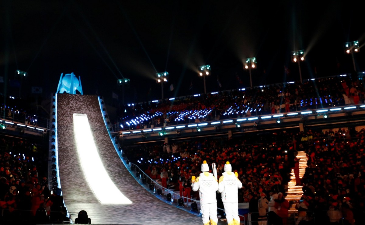 Unified Korea torchbearers, North Korean Jong Su Hyon and South Korean Park Jong-ah hold the Olympic Flame before the lighting of the cauldron.
