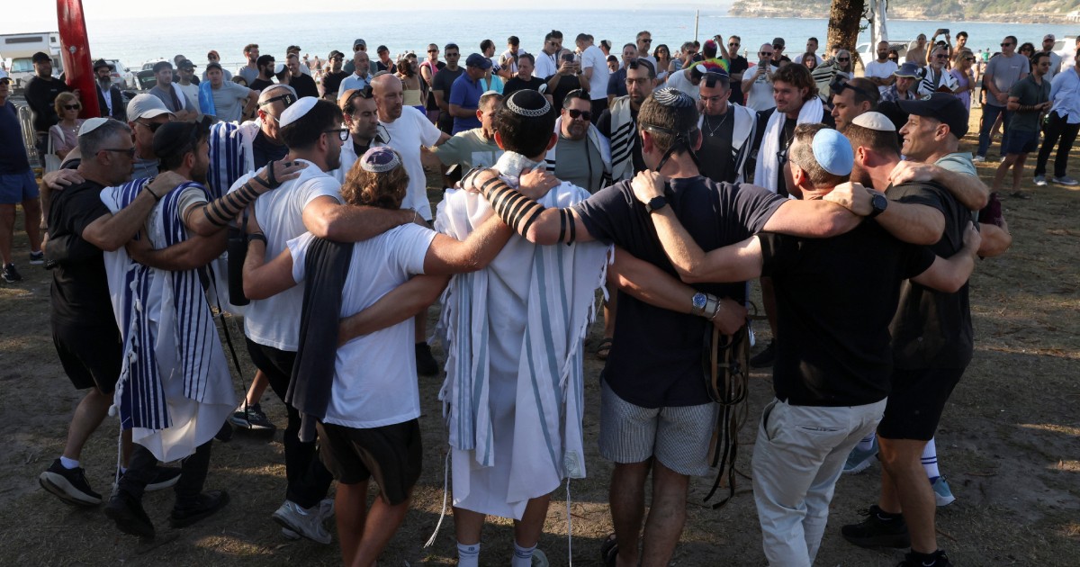 Australian Jews hold prayers, hundreds of surfers paddle out at Bondi to honour shooting victims