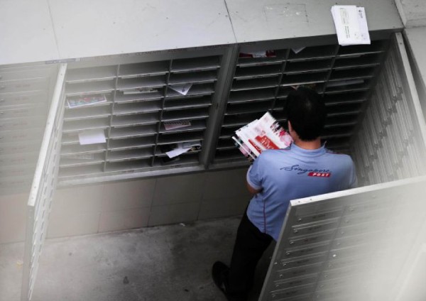 SingPost apologises for service failures during year-end peak season, even as postmen pull extra hours